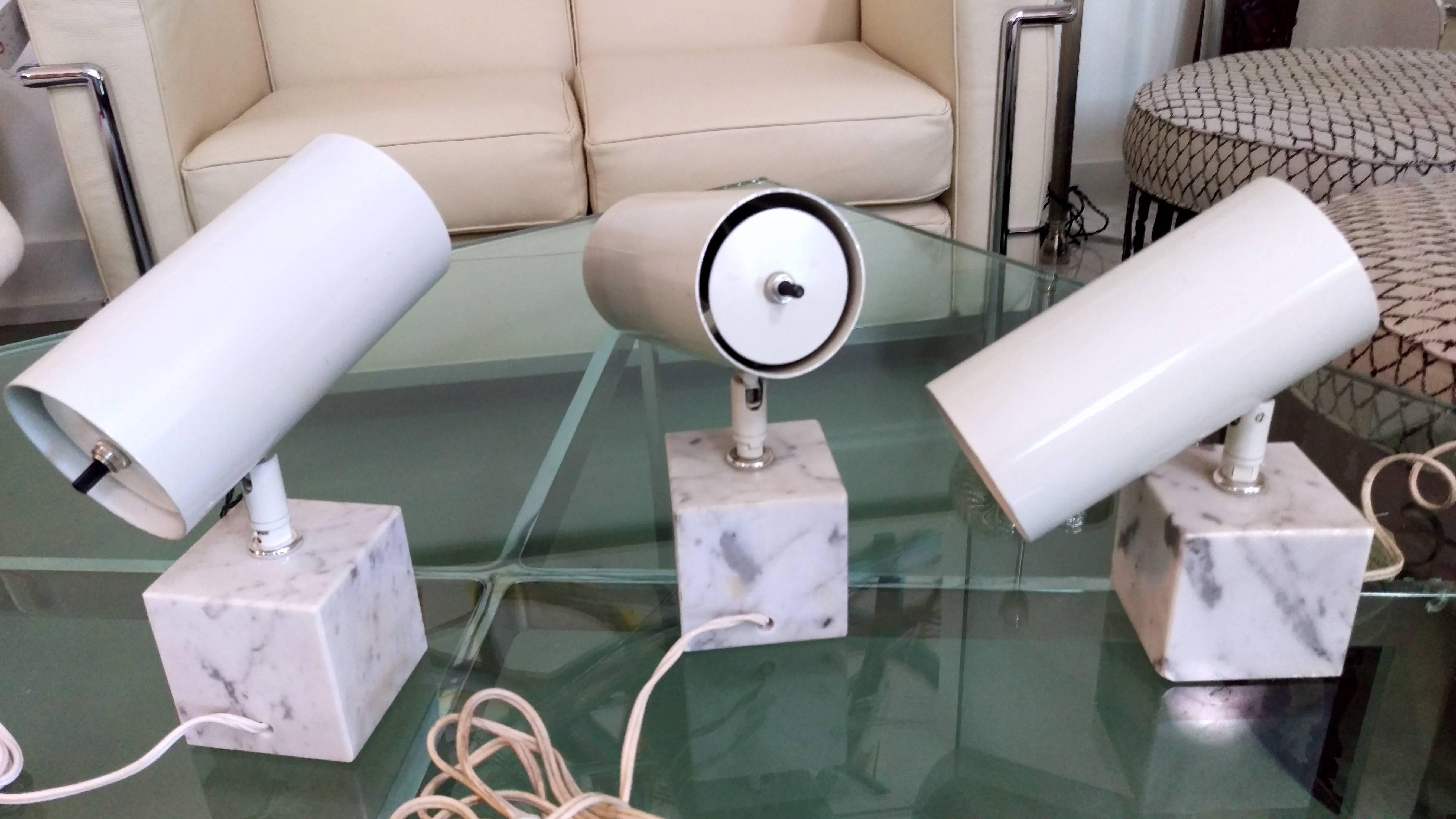 Very unique set of three Koch & Lowy Italian marble base table lamps. All in white lacquered metal cylinder shades (one still retains original tag and apparently never been used as new old stock item). Shade can pivot in all angles as desired.