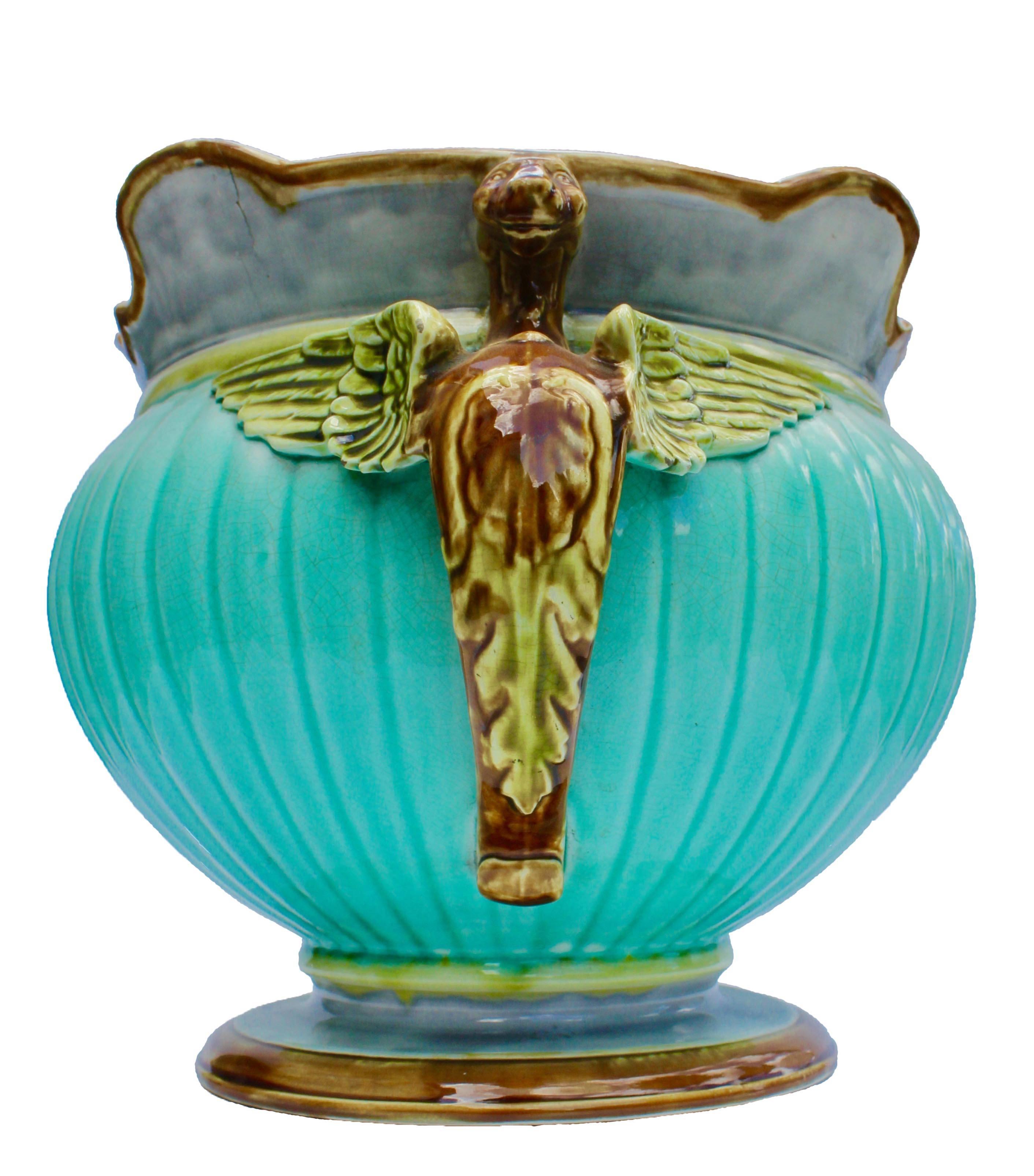 A rare and beautiful Majolica glazed ceramic jardiniere, circa 1920. Fabulous colors, with flying dragon handles. Unmarked. Very good original condition. (See pictures, just a small crack visible on the edge of the inside, and a small chip on the