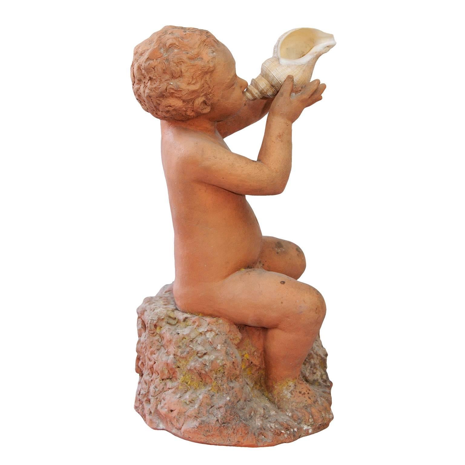 This is a rather beautiful mid-19th century terra cotta putti, he is holding a real shell. This putti has the potential to be adapted and incorporated into a fountain, circa 1860.