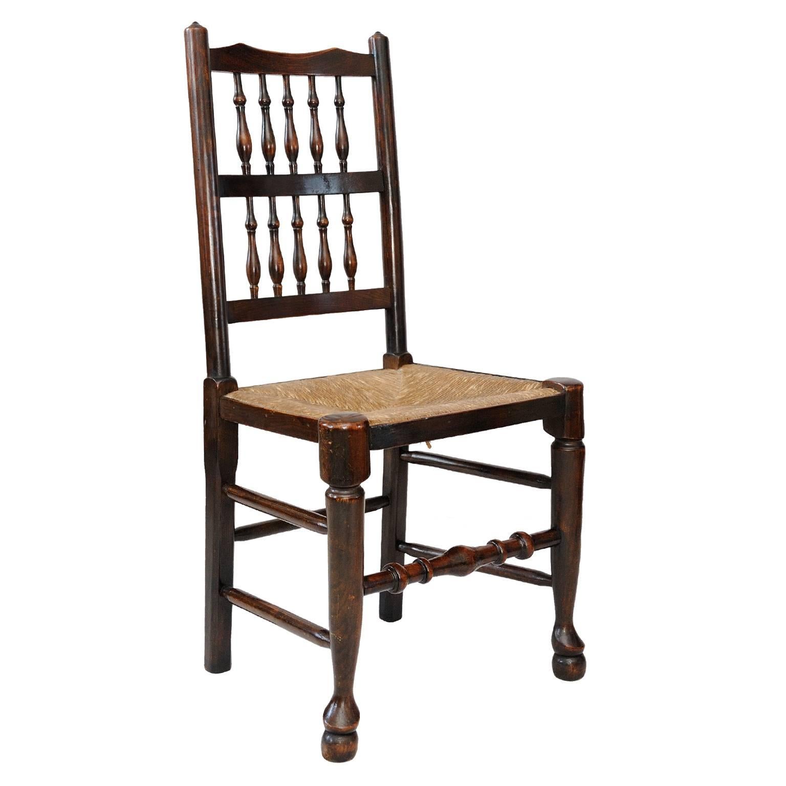 English A Harlequin set of 12 Georgian Oak and Elm Spindle Back Chairs, circa 1820 For Sale