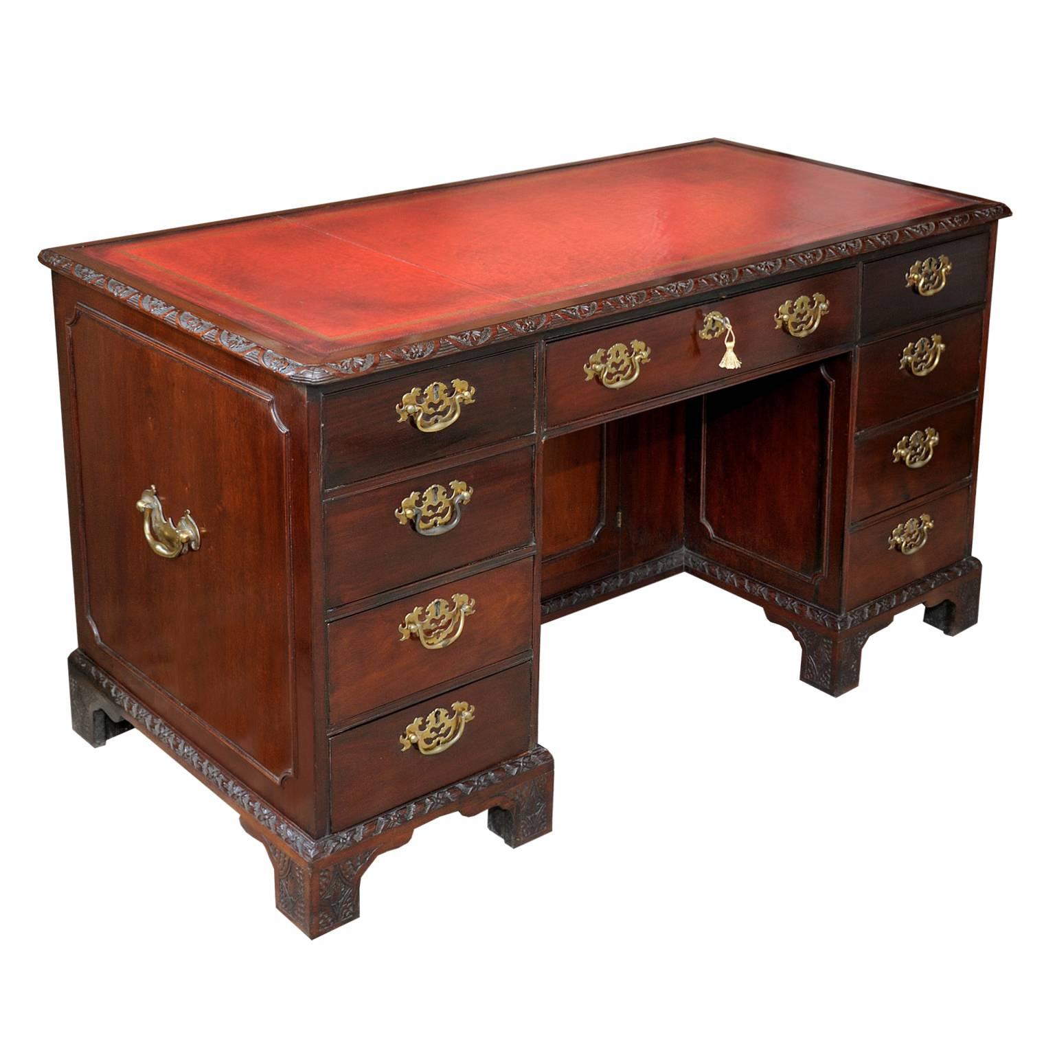 This is a very fine quality mid-19th century Chippendale style mahogany desk with a superb red tooled leather top, the desk features original locks with working keys and complete with carrying handles to the sides. This superb medium size desk would