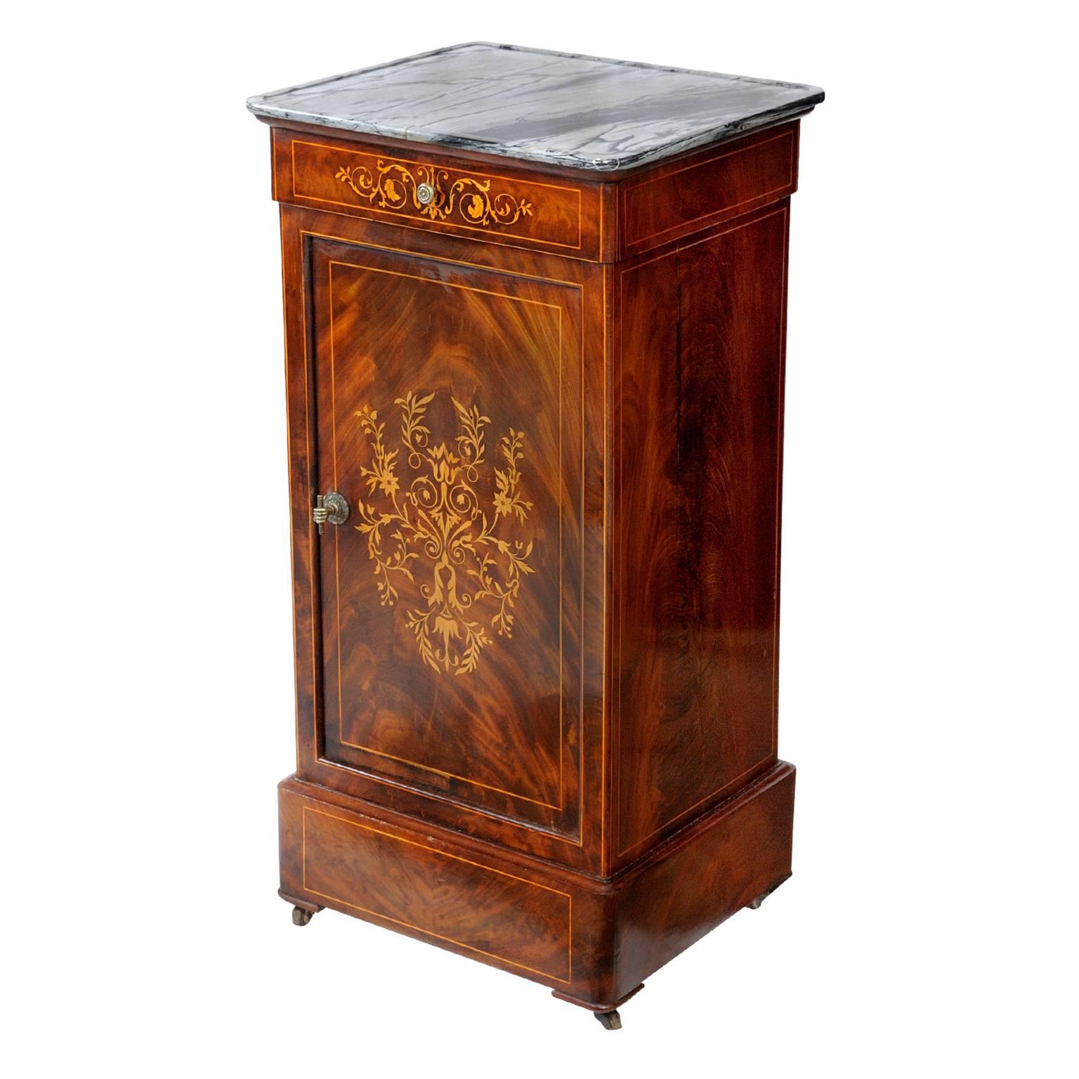 This is a quite superb French early 19th century mahogany night or bedside table with beautifully detailed inlays and a lovely grey marble top. The stand has a compartment with two shelves, one being made of marble and is complete with its original