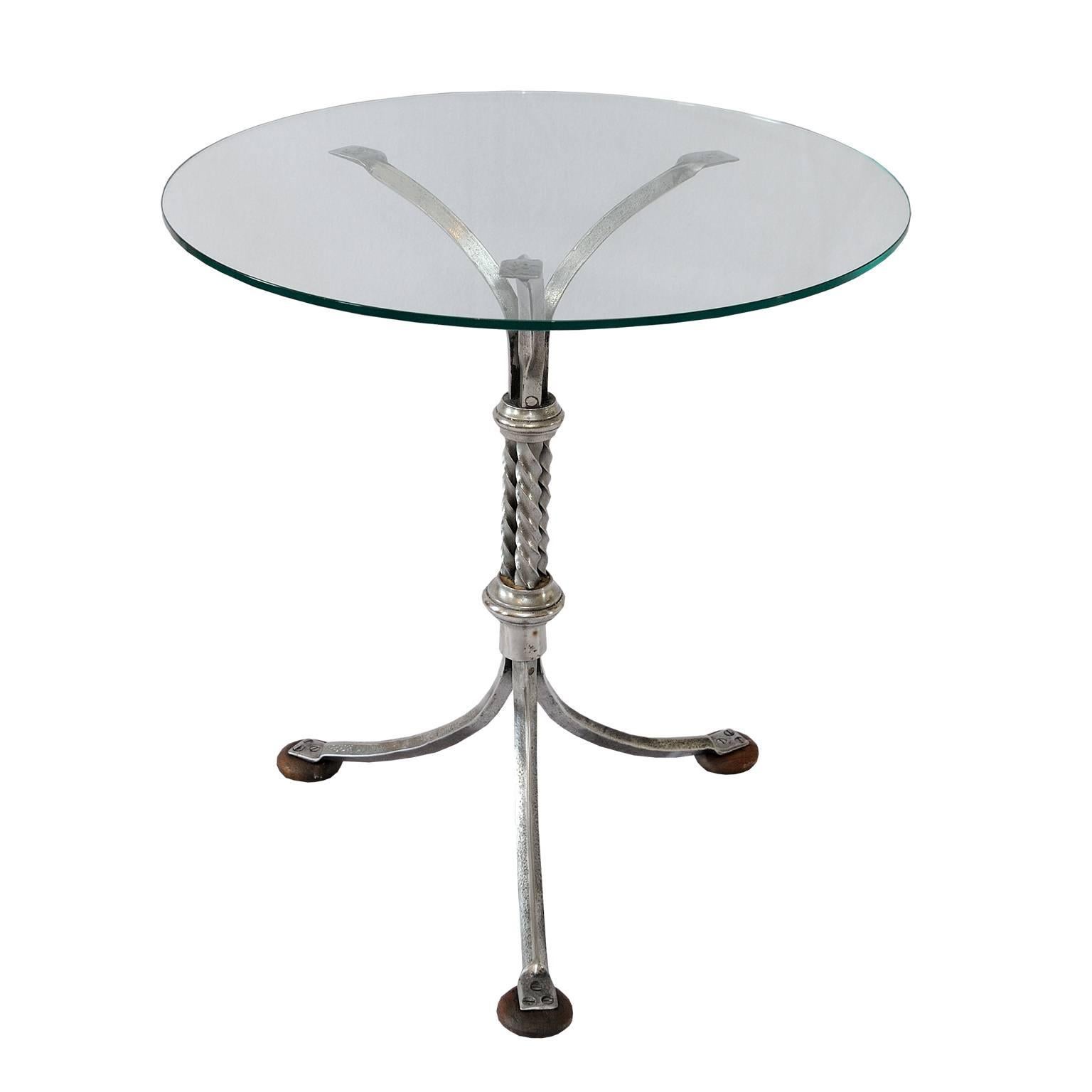 This is a superb pair of mid-19th century polished wrought iron ships tables with contemporary polished glass tops. (The tables now have small mahogany bun feet which could be removed if you wish to screw the tables to the deck of a boat or Yacht,