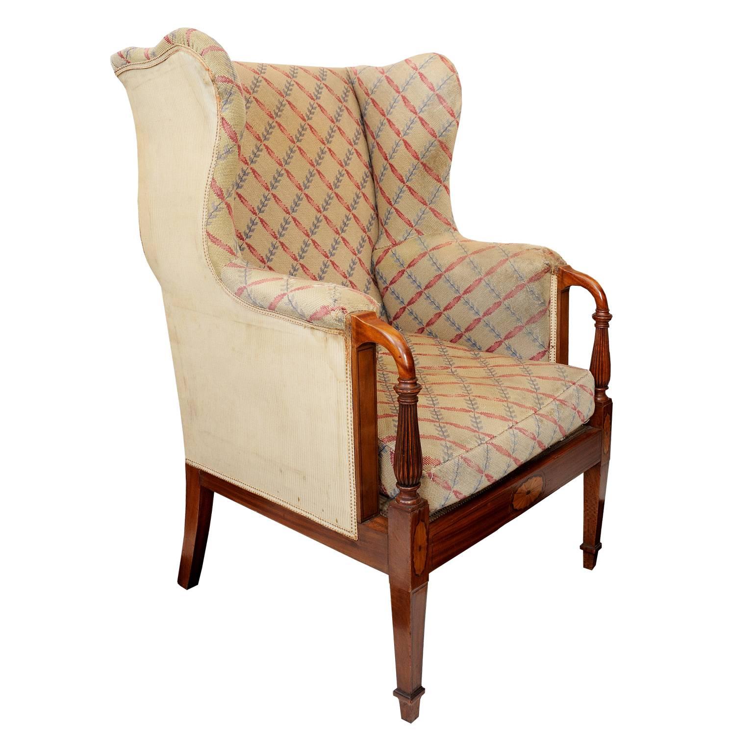 This is a superb and rare pair of late 19th century English Country House solid satinwood wing chairs, retaining their original needle point fabric covering, circa 1890.

Made by the famous English furniture company "Waring & Gillow"