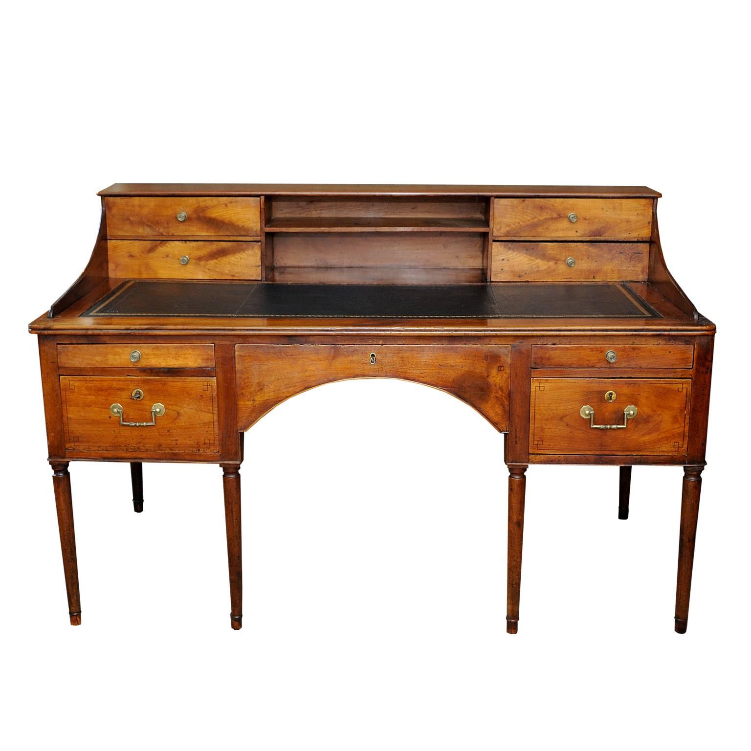 This is large and really quite beautiful French late 18th century Louis XVI period solid cherrywood writing table/desk featuring drawers/locks and pigeon holes and a black gilt tooled leather top and slide (purchased by us from the estate office of