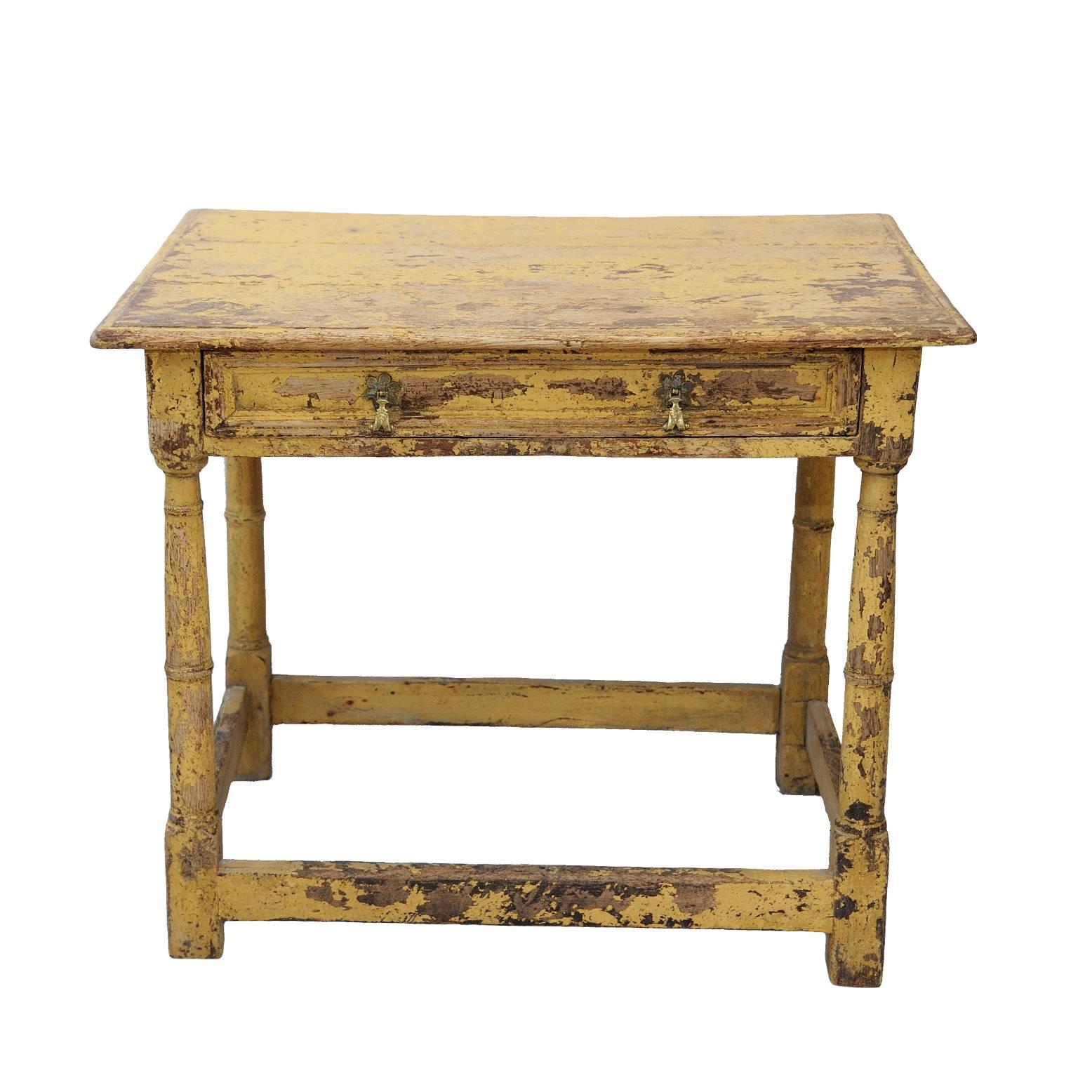 This is a highly sought after and beautifully proportioned English George I early 18th century oak painted side table with drawer to the front, turned legs and flat stretchers, the paintwork has been refreshed, circa 1720.