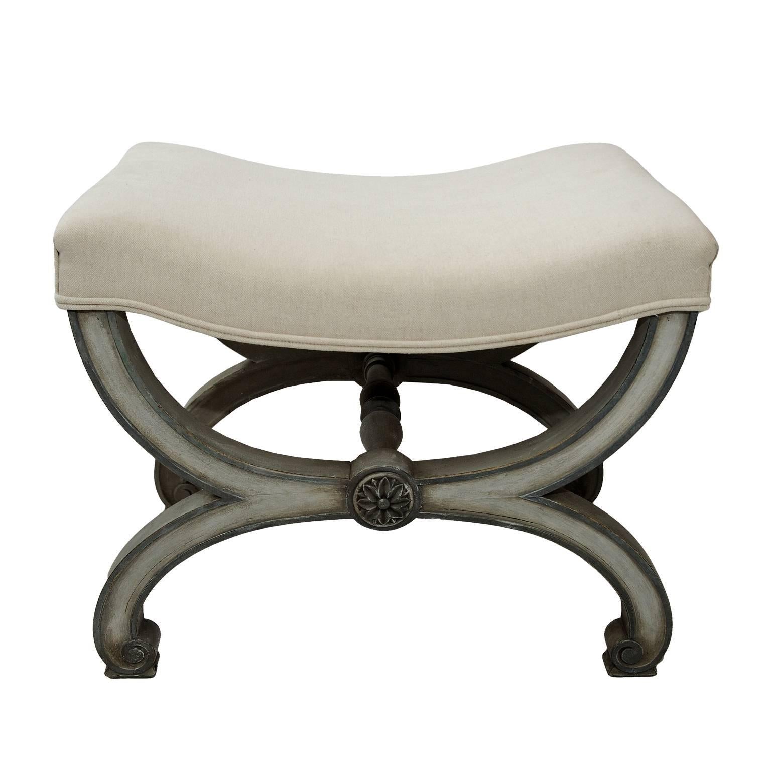 This is a very pretty Louis XVI style, painted X-frame stool, upholstered in cream Scottish Linen, circa 1860 

The X-frame is beautifully detailed with a central carved flower design and the painted frame and cream linen make for a most striking