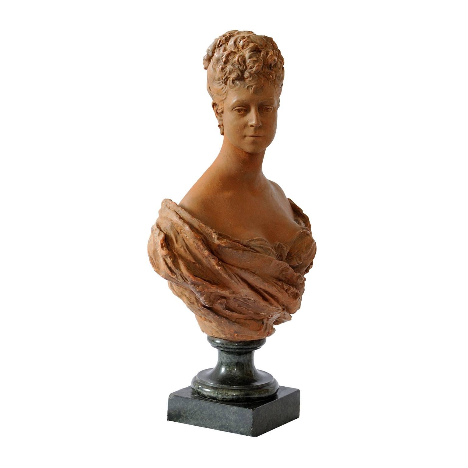 This is a rather beautiful French mid-19th century terracotta bust of a young 18th century noble woman standing on a green marble base, circa 1860.