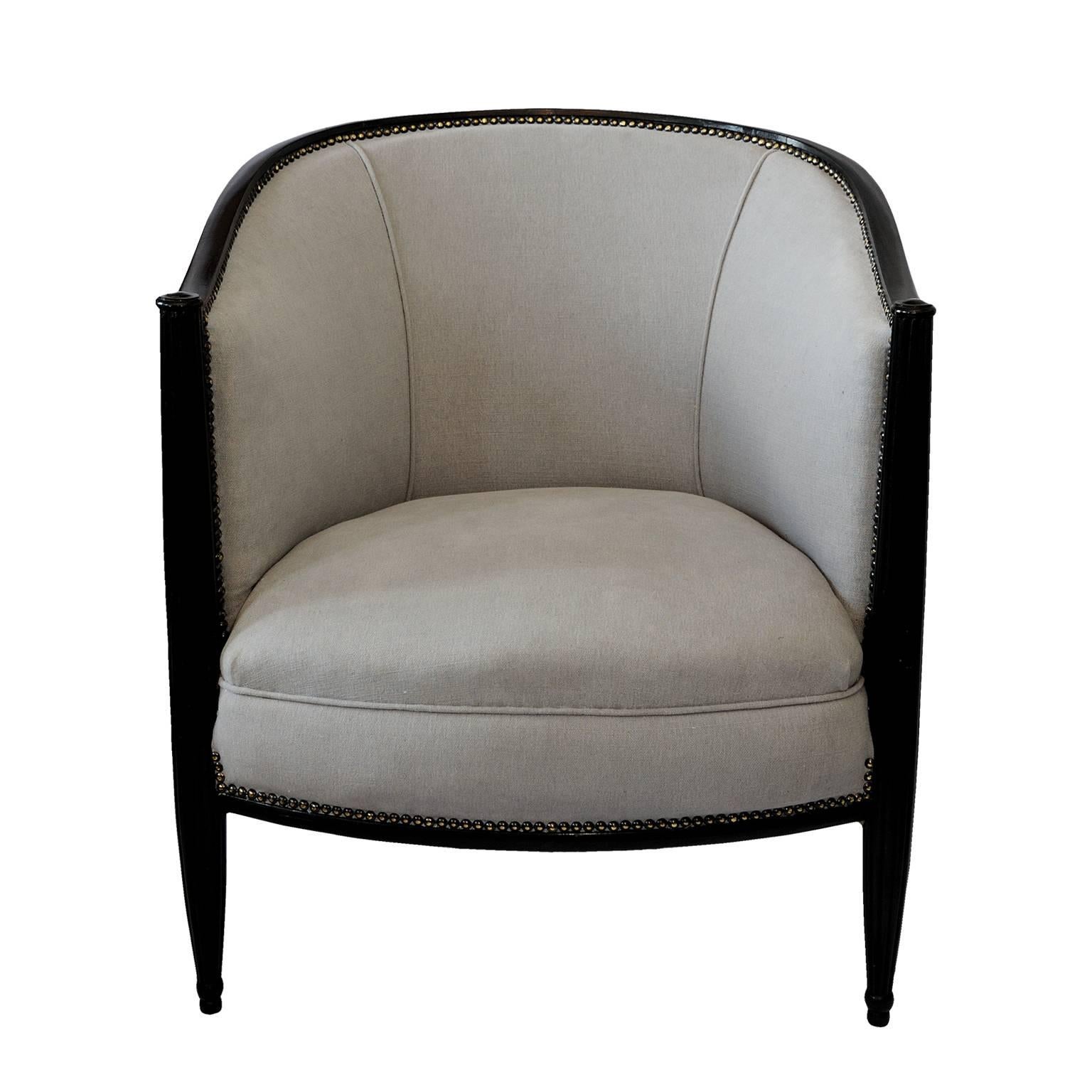 This is a wonderful, very comfortable and stylish French Art Deco ebonized Tub chair, now upholstered in a very smart light grey Scottish linen, circa 1930.
