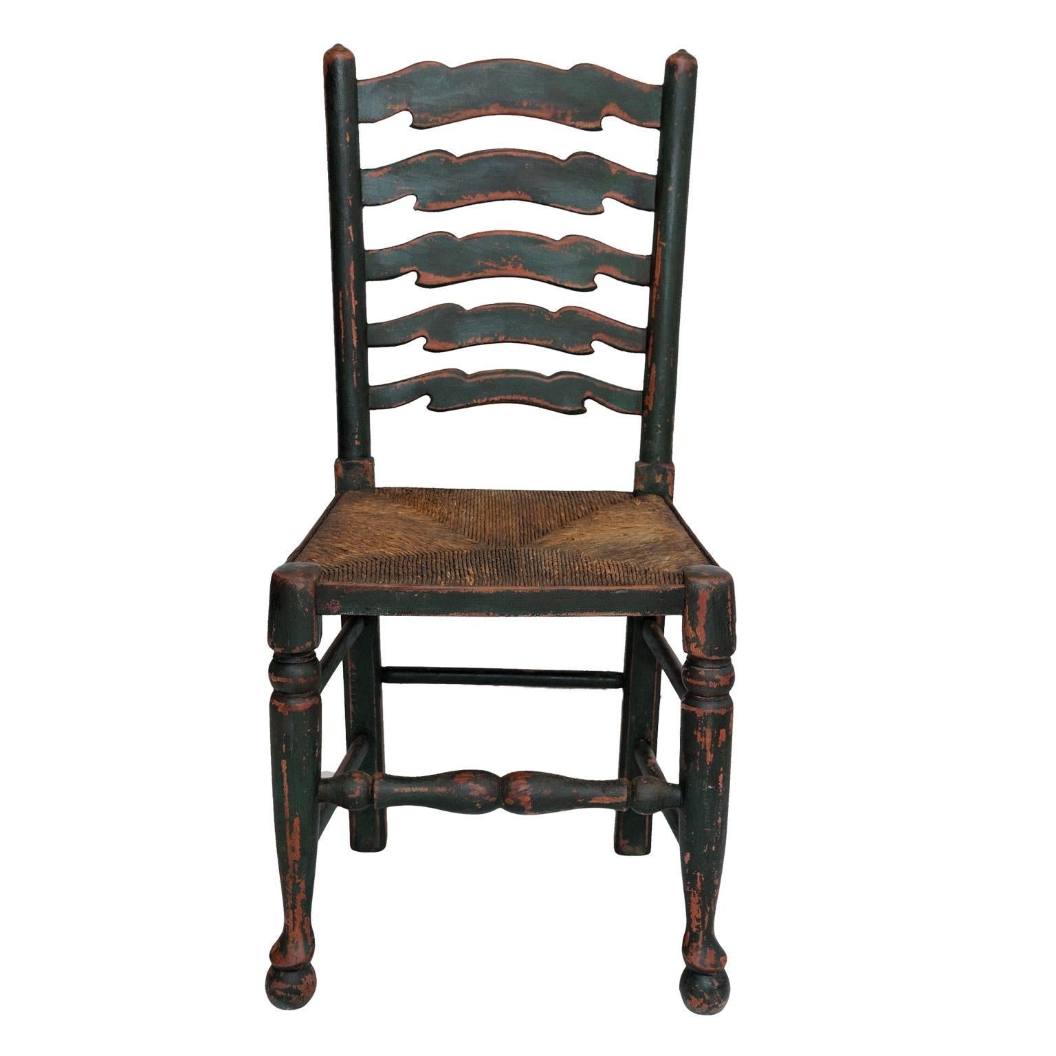 This is a lovely set of six English oak painted mid-19th century ladder back chairs with rush seats. All the chairs are in very good usable condition, circa 1860.