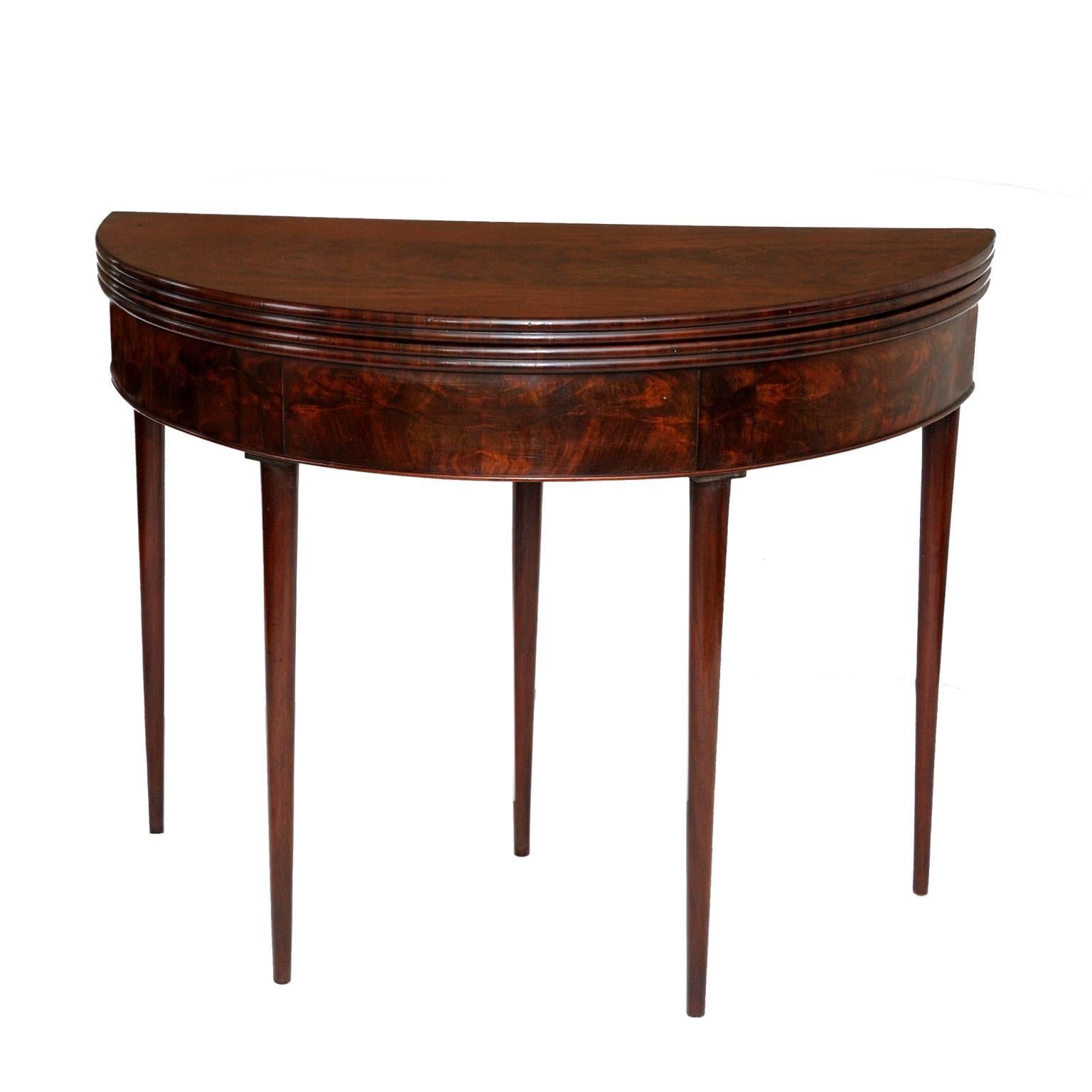This is a beautifully proportioned and very attractive French late 18th century Louis XVI flame mahogany circular card table, retaining its original tooled red baize interior with pull-out drawer for cards etc, circa 1780.