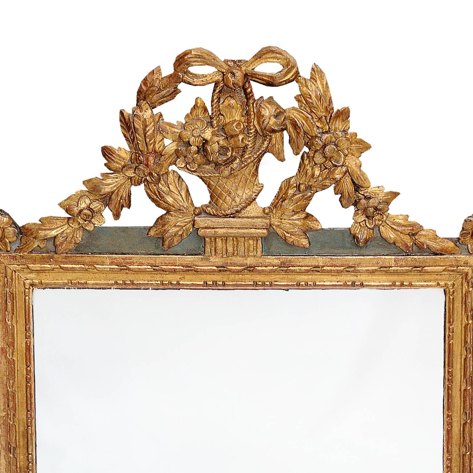 This is a very striking Northern French late 18th century Louis XVI period painted and carved giltwood mirror with original carved floral basket and ribbon decoration and later mirror plate, circa 1780.