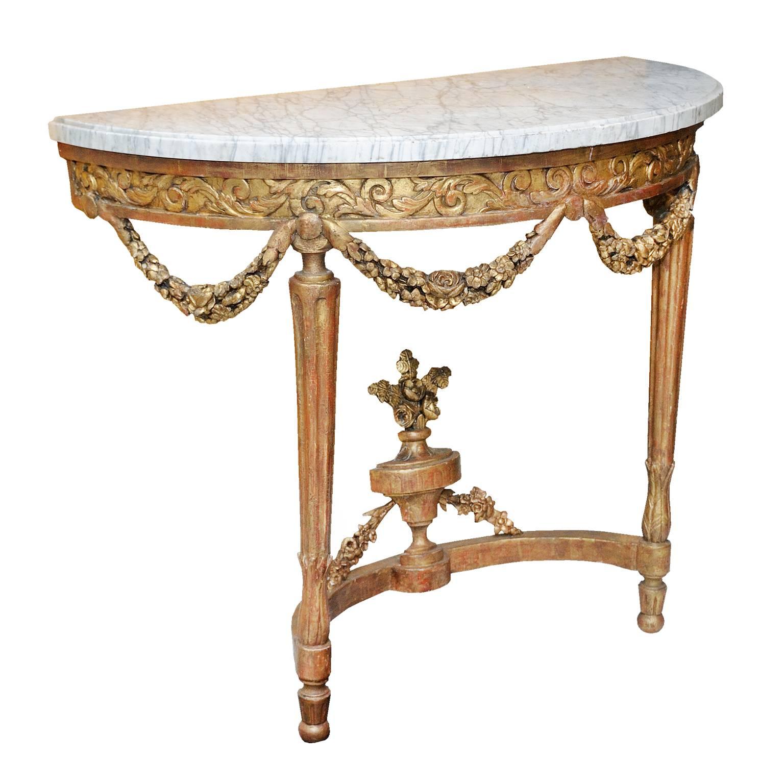 This is a quite beautiful Italian 18th century Louis XVI period carved giltwood console with neoclassical fluted legs and white and grey Carrara marble top, circa 1780.
  