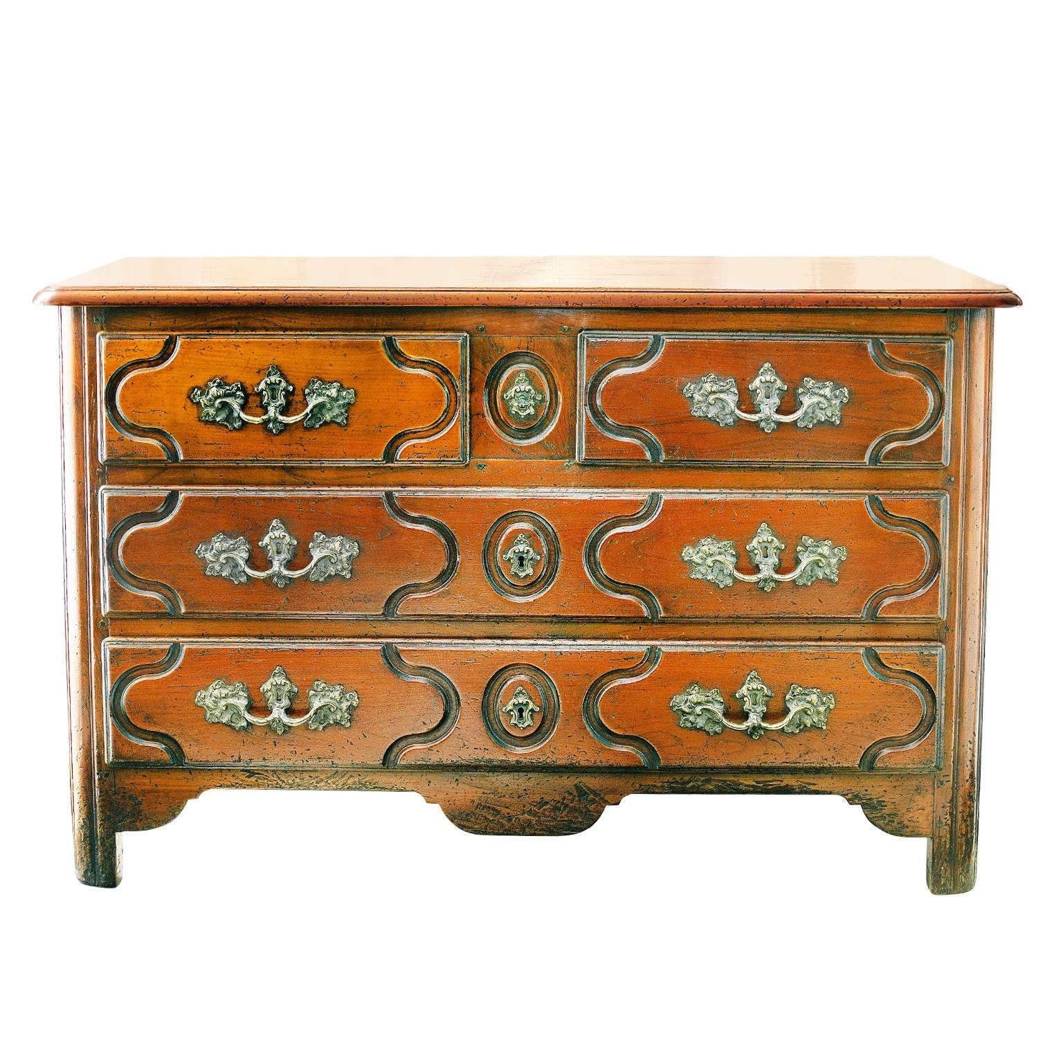 This is a wonderful 19th century Louis XV style cherrywood commode with two long and two half drawers and panelled sides, the piece has wonderful color and is fitted with very attractive brass furniture, complete with locks and key, circa 1880.