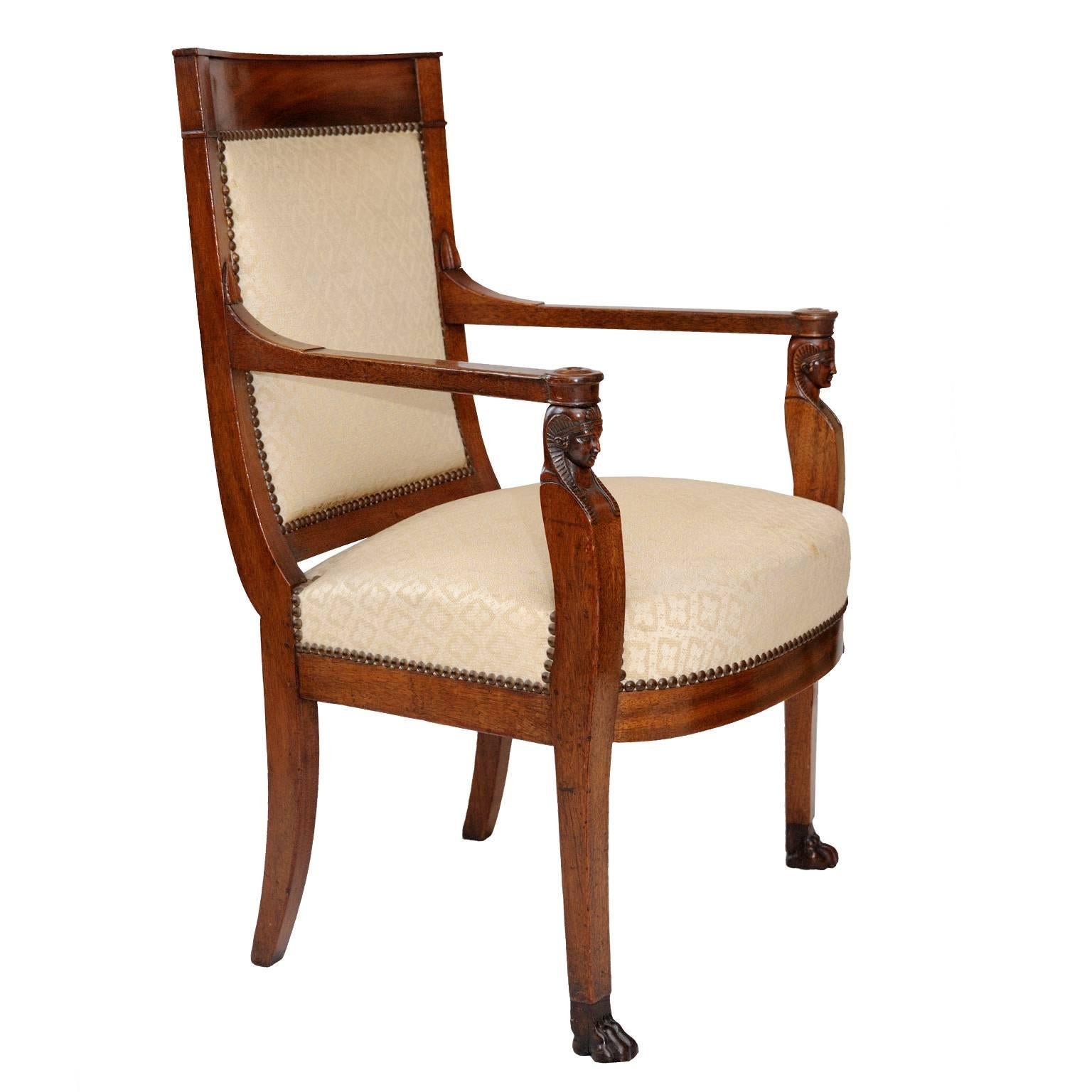 This is a wonderful example of French 19th century Napoleonic Empire Furniture. This armchair is made of mahogany and features carved Egyptian heads on the arms, circa 1805.

Napoleon imposed strict control of artistic production (among all other