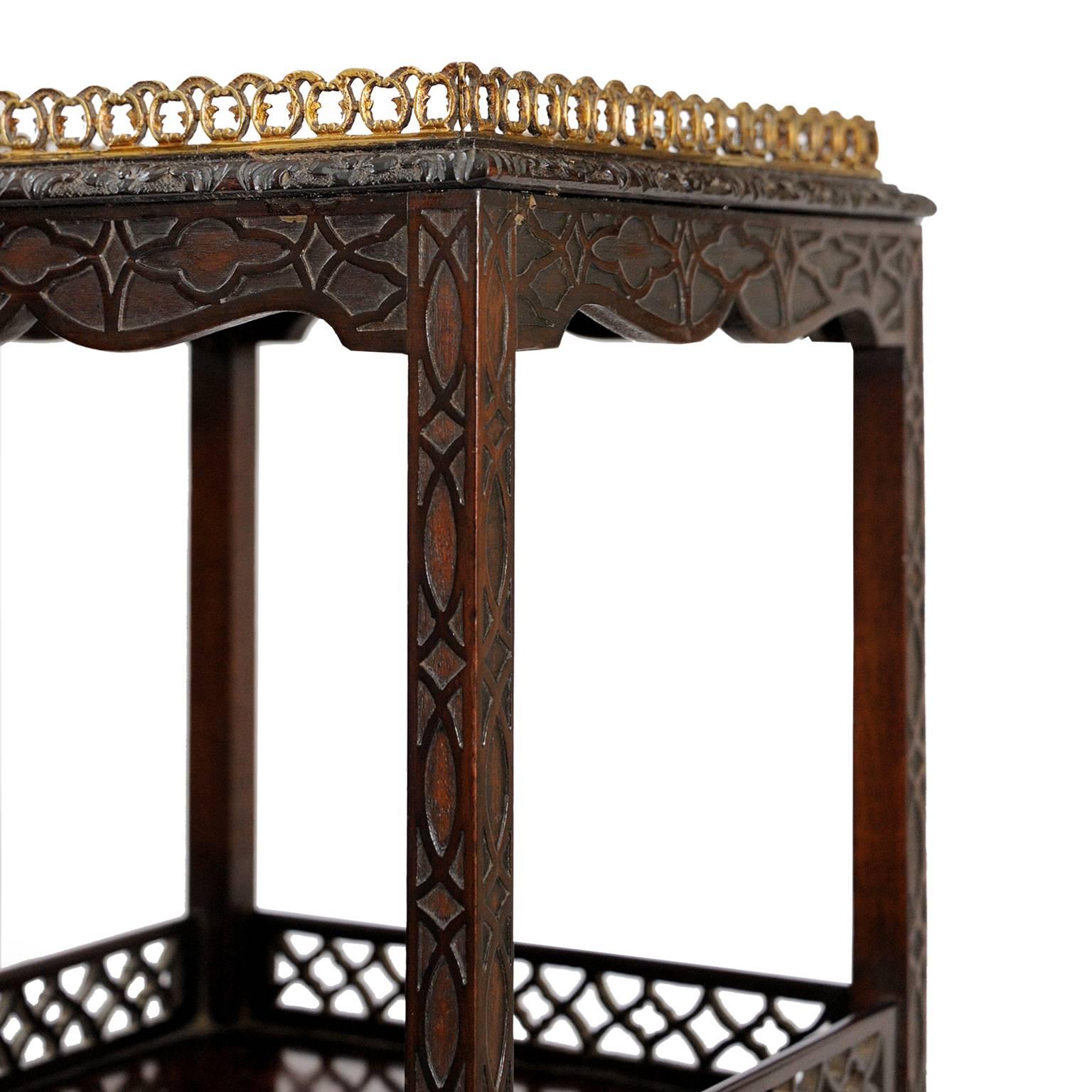 This is a very attractive 18th century George III stand, featuring later Chinese Chippendale style carving, made from mahogany and with a smart brass gallery, circa 1780.