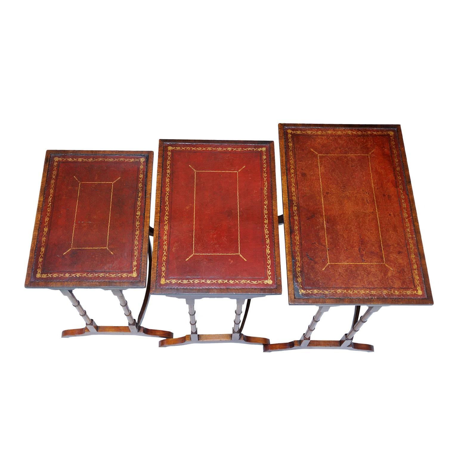 This is ​very useful nest of three late 19th century Georgian style mahogany side tables, retaining their original tooled leather tops, still retaining a beautiful rich red color, circa 1890.