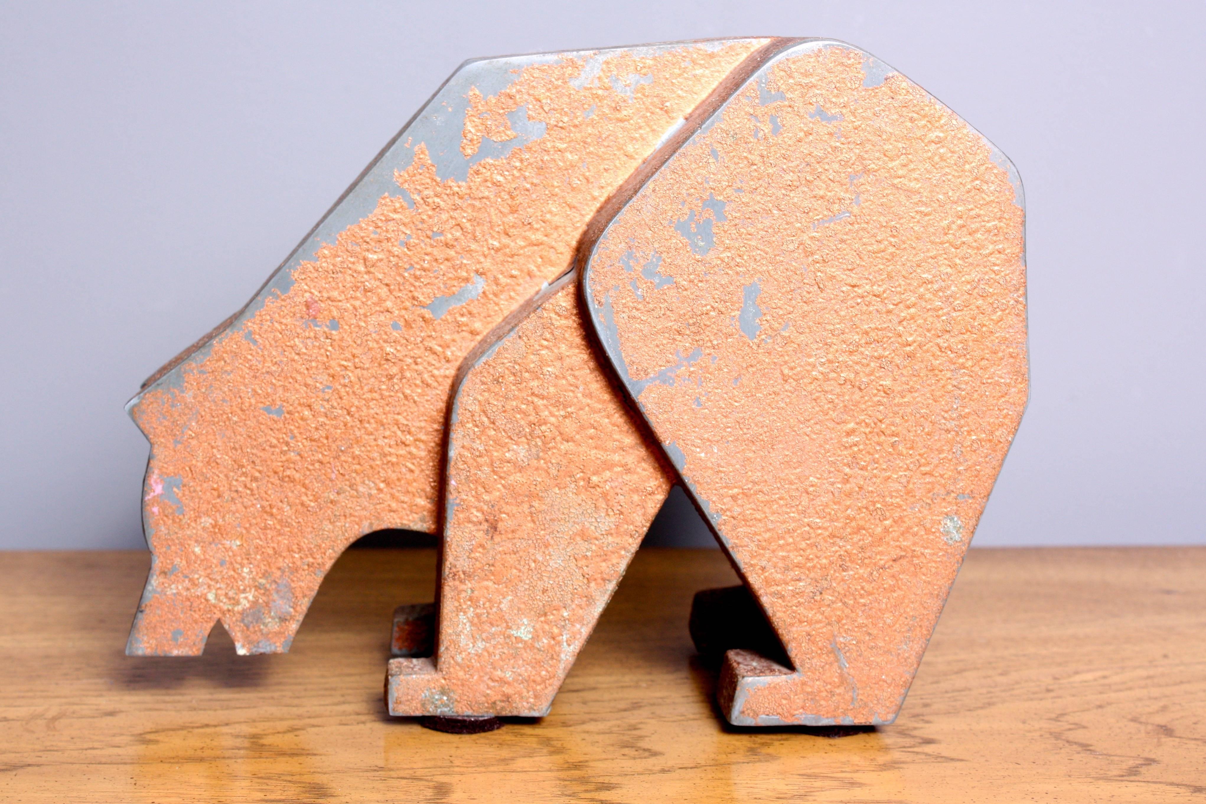 This metal bear was said to be mounted outside a retail store as an advertising piece. This charming store display features a textured gold aluminum coating. Although it's not clear exactly what merchandise this bear represents, this unique and