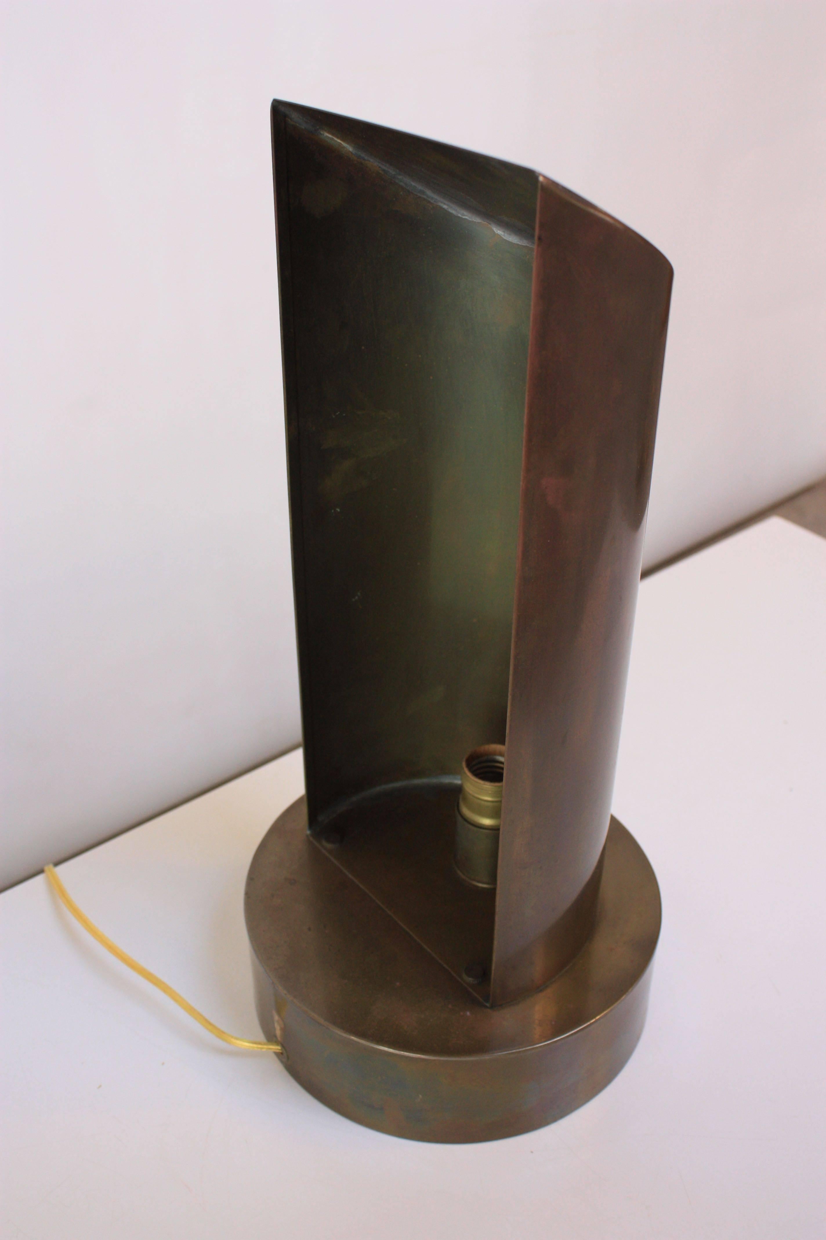 This table sconce was designed by Chapman in the 1970s combining Industrial and modern design. Comprised entirely of brass this piece also features the signature bronze finish and dimmer 'ball' knob.