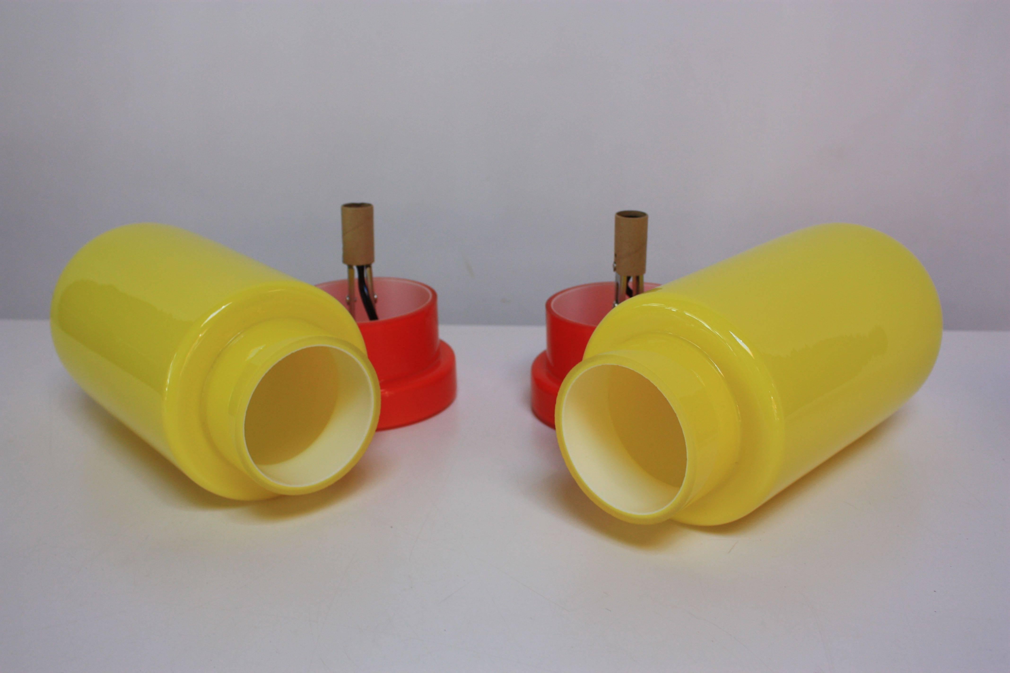 This pair of 1960s Swedish 'Capsule' lamps shine in neon yellow and red blown glass. They are in mint condition with the original Swedish stickers still in tact. They have been rewired.