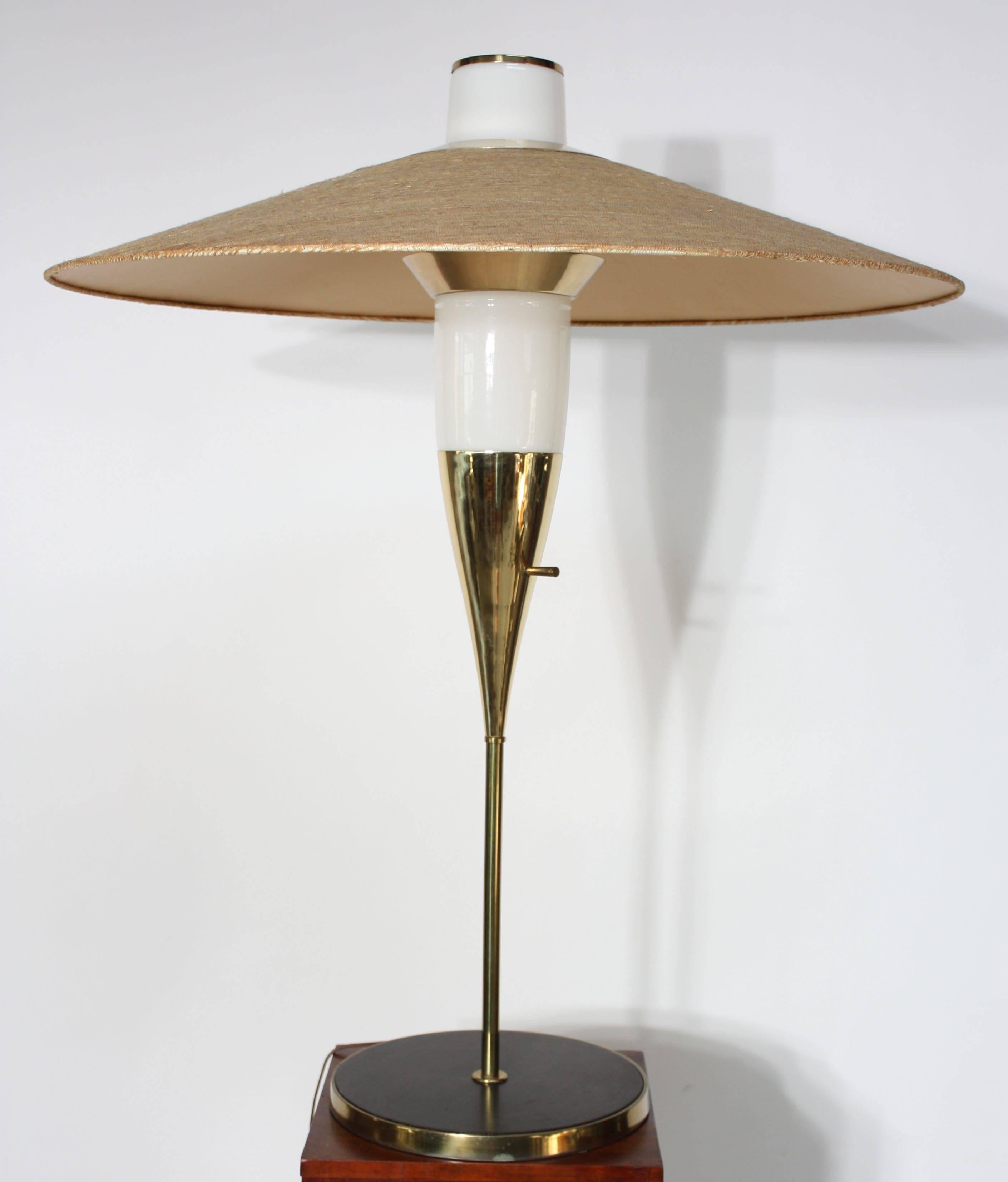 This extremely rare table lamp was designed by Raymond Loewy for Stiffel in 1957. This model (#9659) is only present in the 1957 Stiffel catalog and is therefore believed to have been in production for that year alone. It is composed of a rosewood