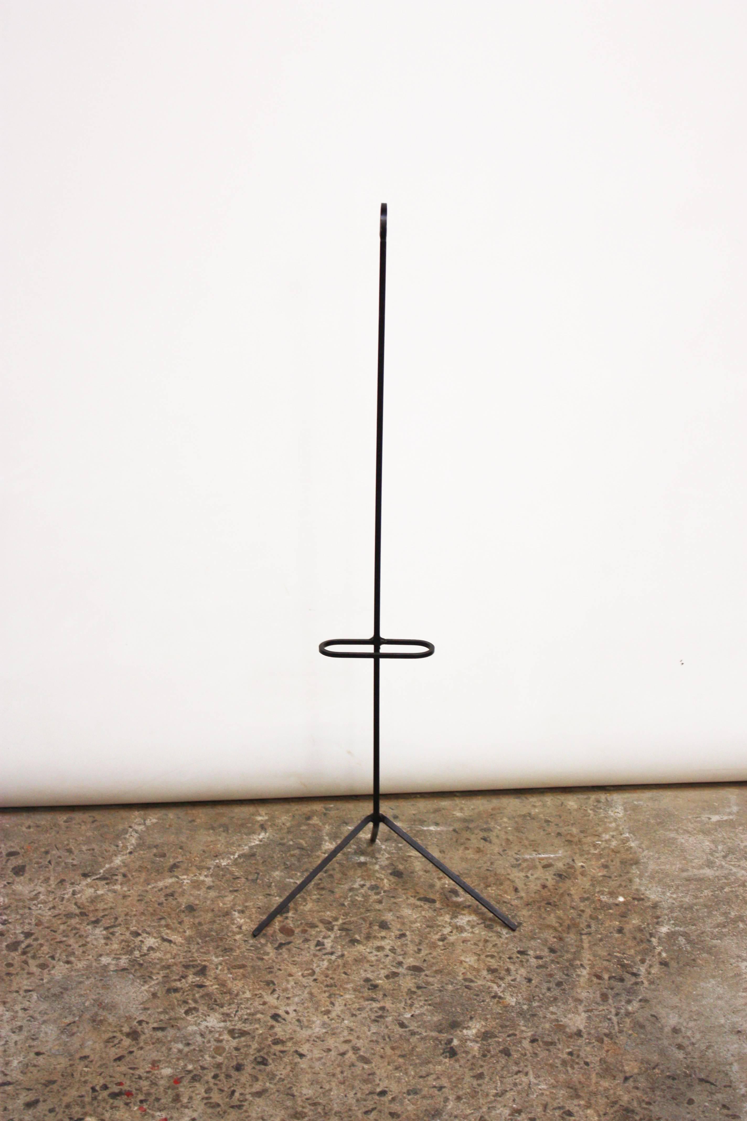 This unusual wrought iron valet is elegant in its simplicity. The frame is a continuous piece of wrought iron, and the hanger is removable. This is a minimal but stylish take on a standard valet stand.
Length of the base is 14.25