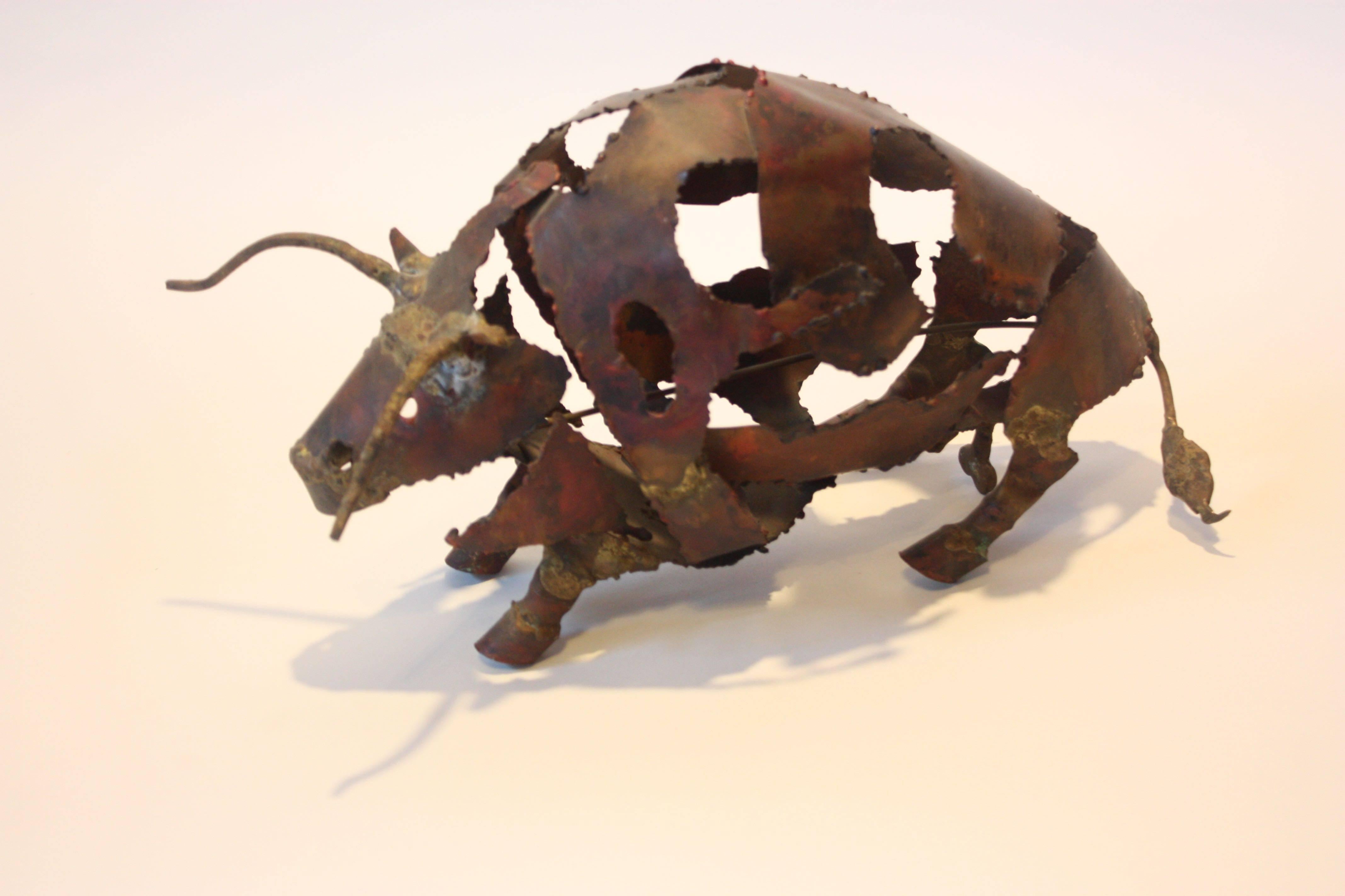 This Brutalist bull sculpture is comprised of a shell of torch cut mixed metal sheets. The legs and horns were soldered on, enhancing the already crude aesthetic... the bulls role in American cultural was none more prevalent than in the mid