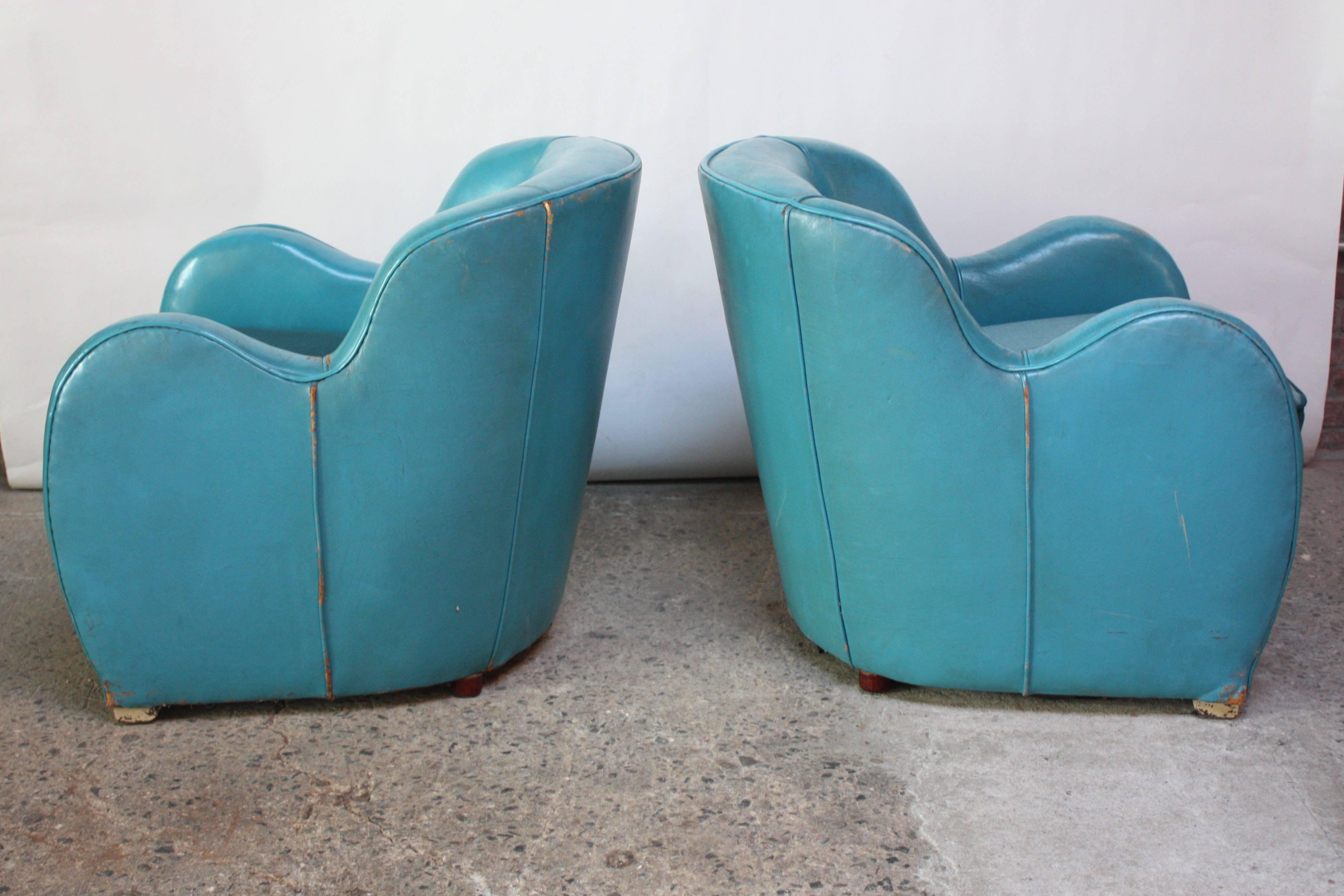 Fantastic pair of lush club chairs with spring seats and turquoise leather frames. The blue velvet cushions and corresponding lining under the loose cushion are a relatively recent addition (past decade or so). Velvet is in excellent, vintage