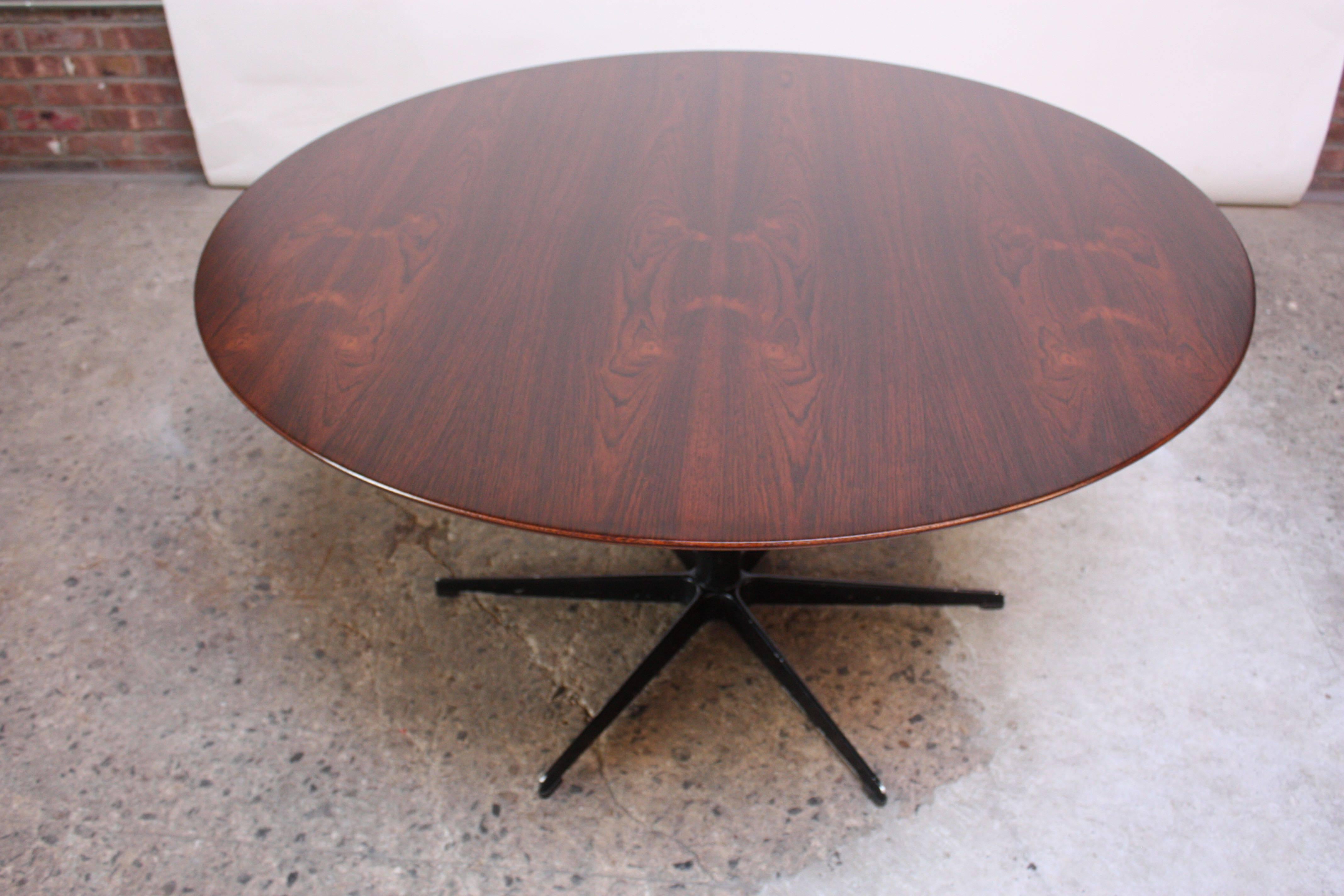 This rosewood table was designed in 1968 by Arne Jacobsen for Fritz Hansen as part of the 'six-star series.' As its name suggests, the lacquered aluminum base fans out into six points and the round top is rosewood (all materials and sizes were