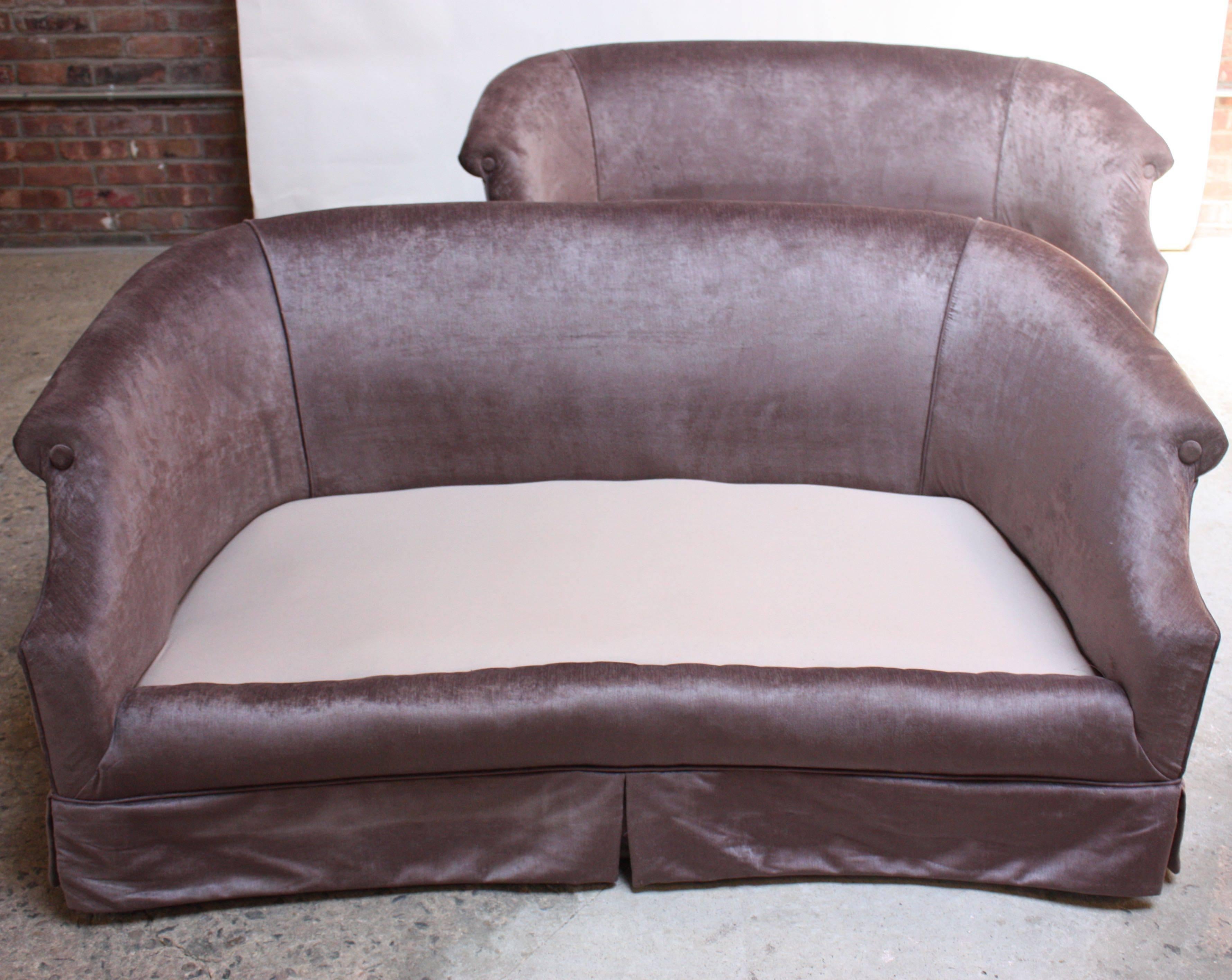 These glamorous settees in light lavender velvet feature low back, rolled-arm frames and spring-construction. The seat cushions were purposefully designed to be relatively high for additional support but could easily be modified and lowered to