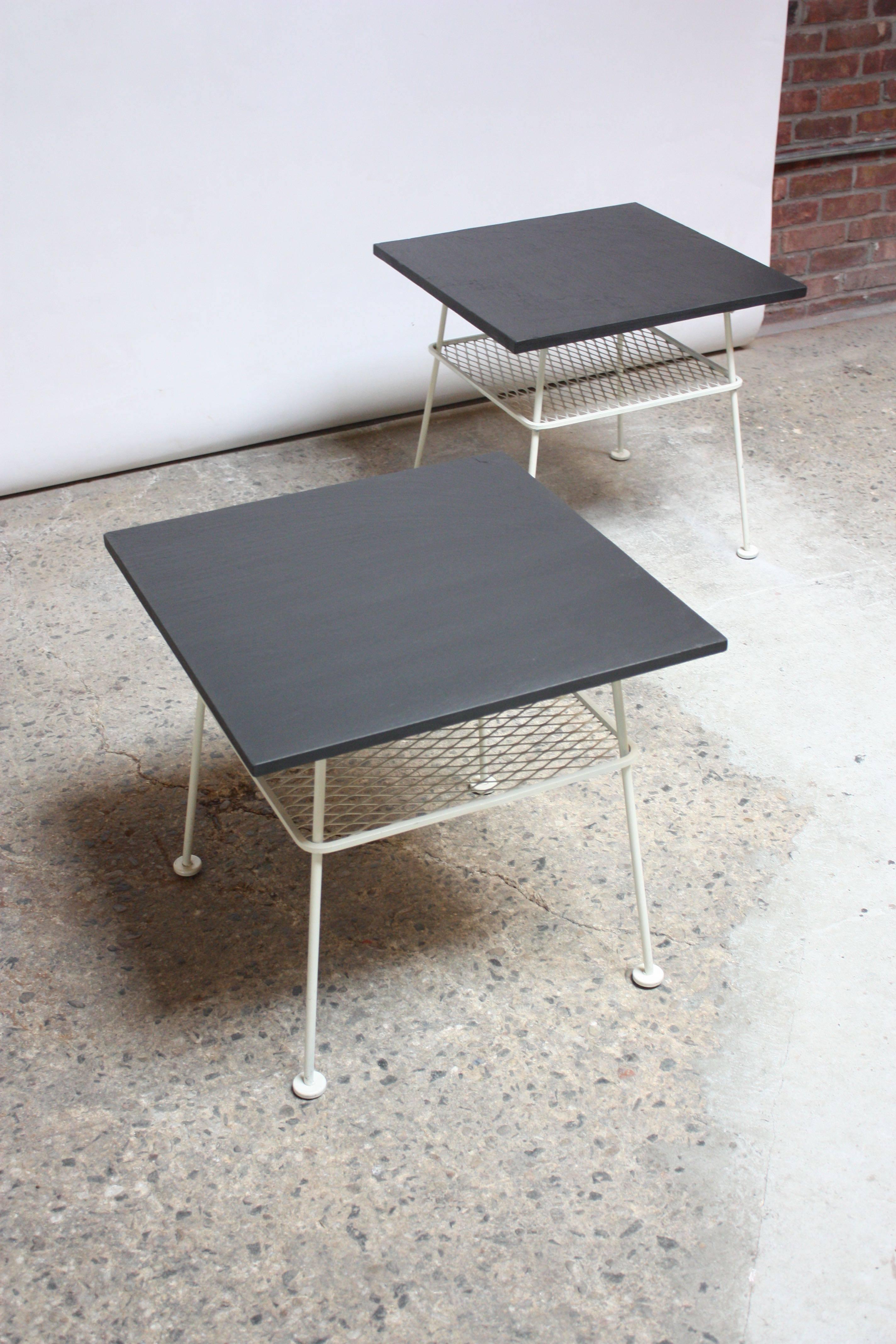These uncommon side tables were designed in the 1950s by Russell Woodard as part of his 'Sculpura' Line. The tops are solid slate, and the wrought iron frames are an off-white with a mesh lower tier. 
These are in excellent, original shape with