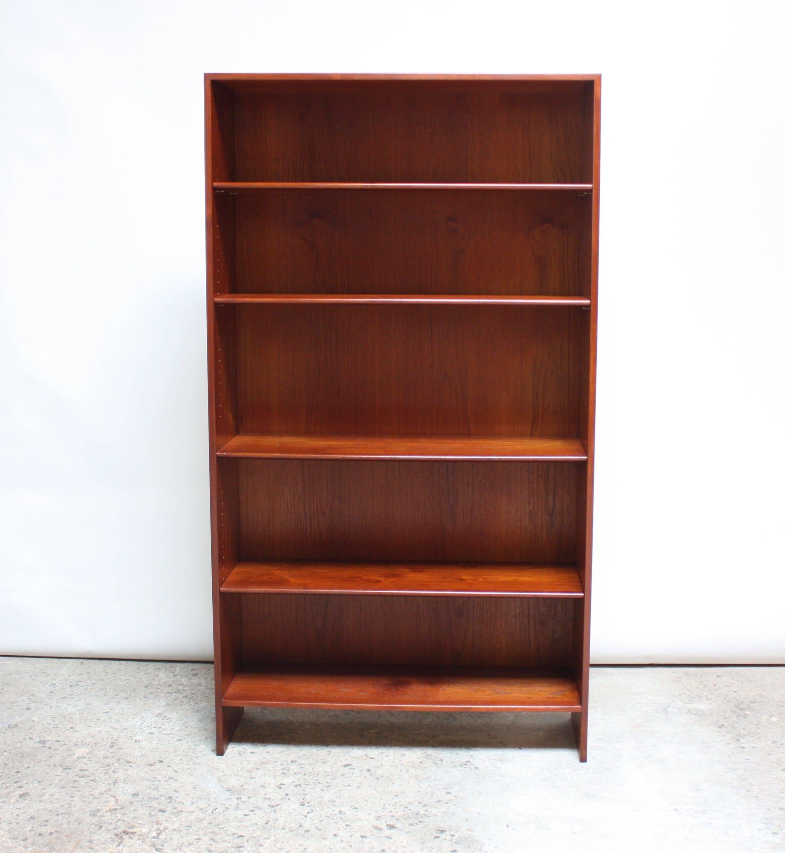 This free-standing bookshelf (model RY 8) was designed by Hans Wegner for Ry Mobler. The more ubiquitous early 1950s examples were made of oak; this lesser seen teak version boasting vivid grain and rich color was manufactured in 1959. Three of the