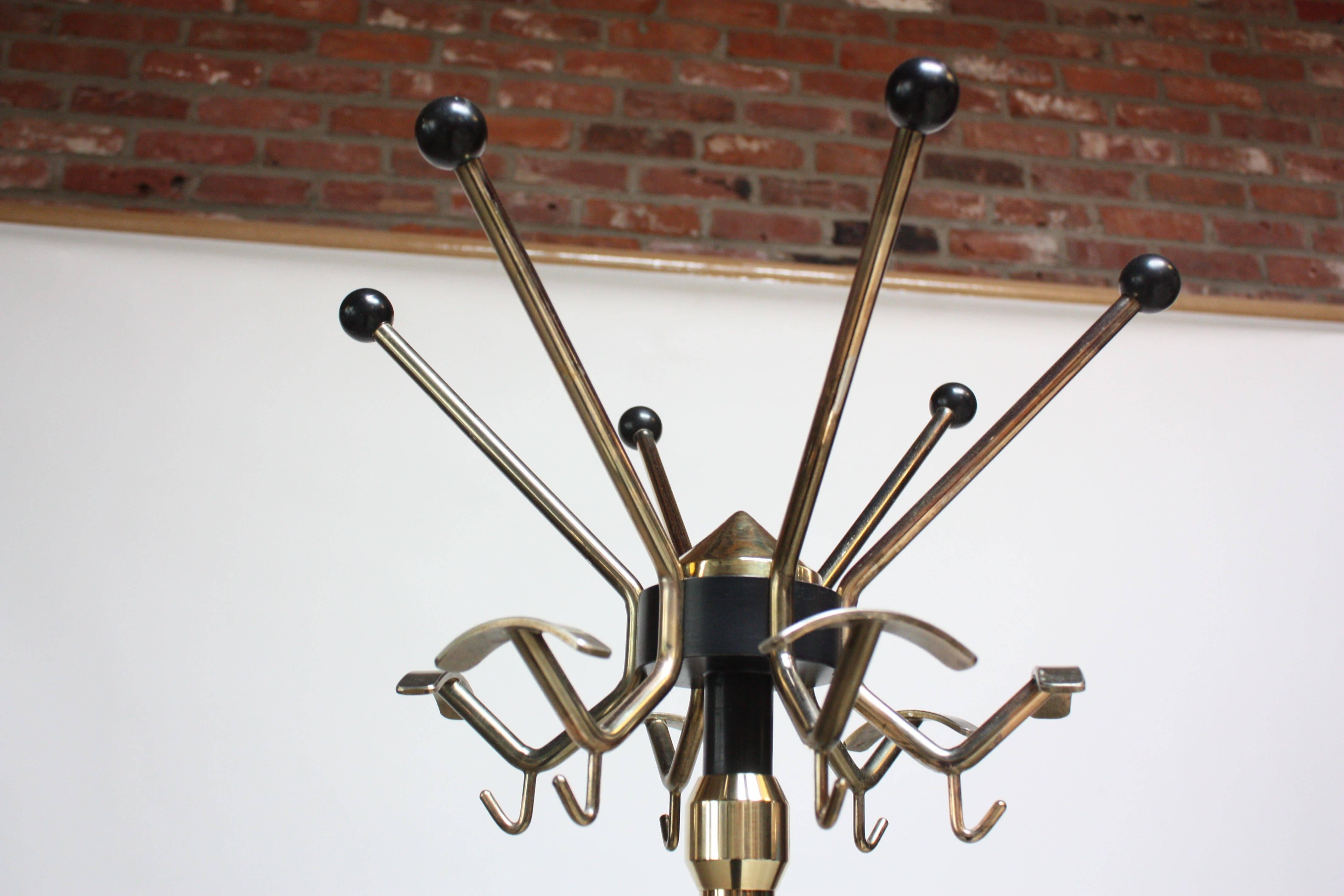 This elegant 1950s Italian Coat / Hat Rack is composed of a swivel-top tier with full-360 degree mobility. The 'x' form painted steel base is supported by cylindrical metal feet.
The top tier (hooks) measures 17