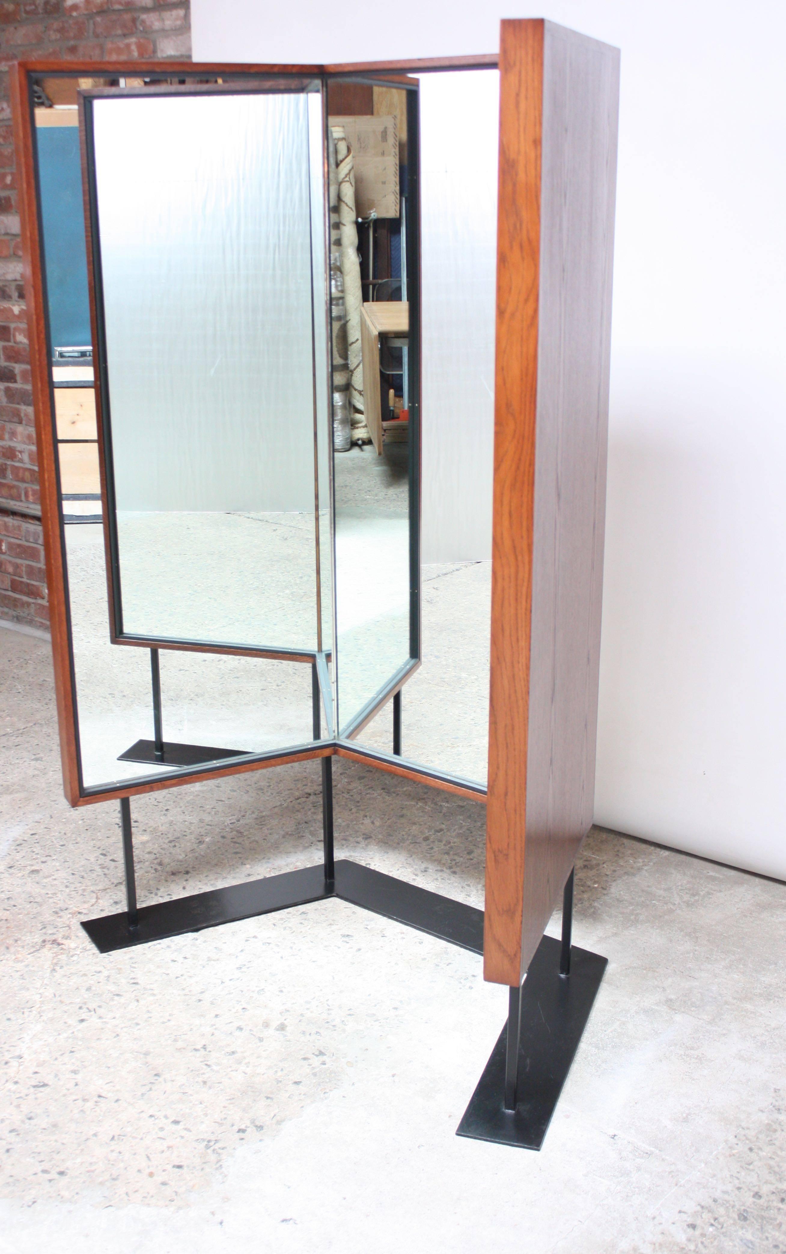Unique-form, custom-made (MA carpenters' union) large tri-panel floor mirror with a stained ash frame, painted black steel base and three separate mirrored glass panels. Despite its tri-fold appearance, the mirror is stationary and the panels do not