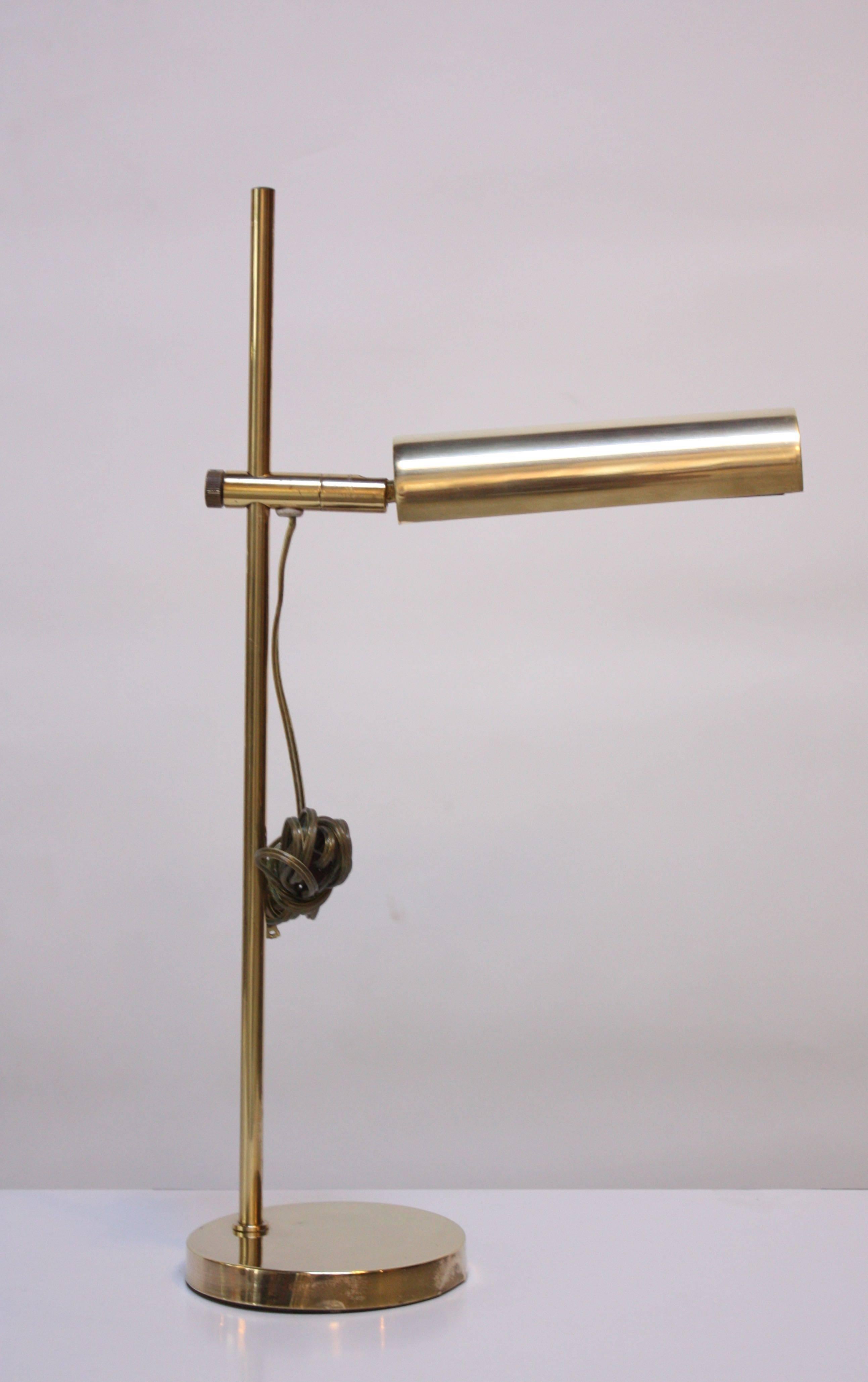 This striking brass table lamp from Koch & Lowy features an adjustable shade offering 360 degree mobility and tilt function. Additionally the shade height is adjustable along the stem. Rewired and ready for use. 
Manufacturer's Mark present.