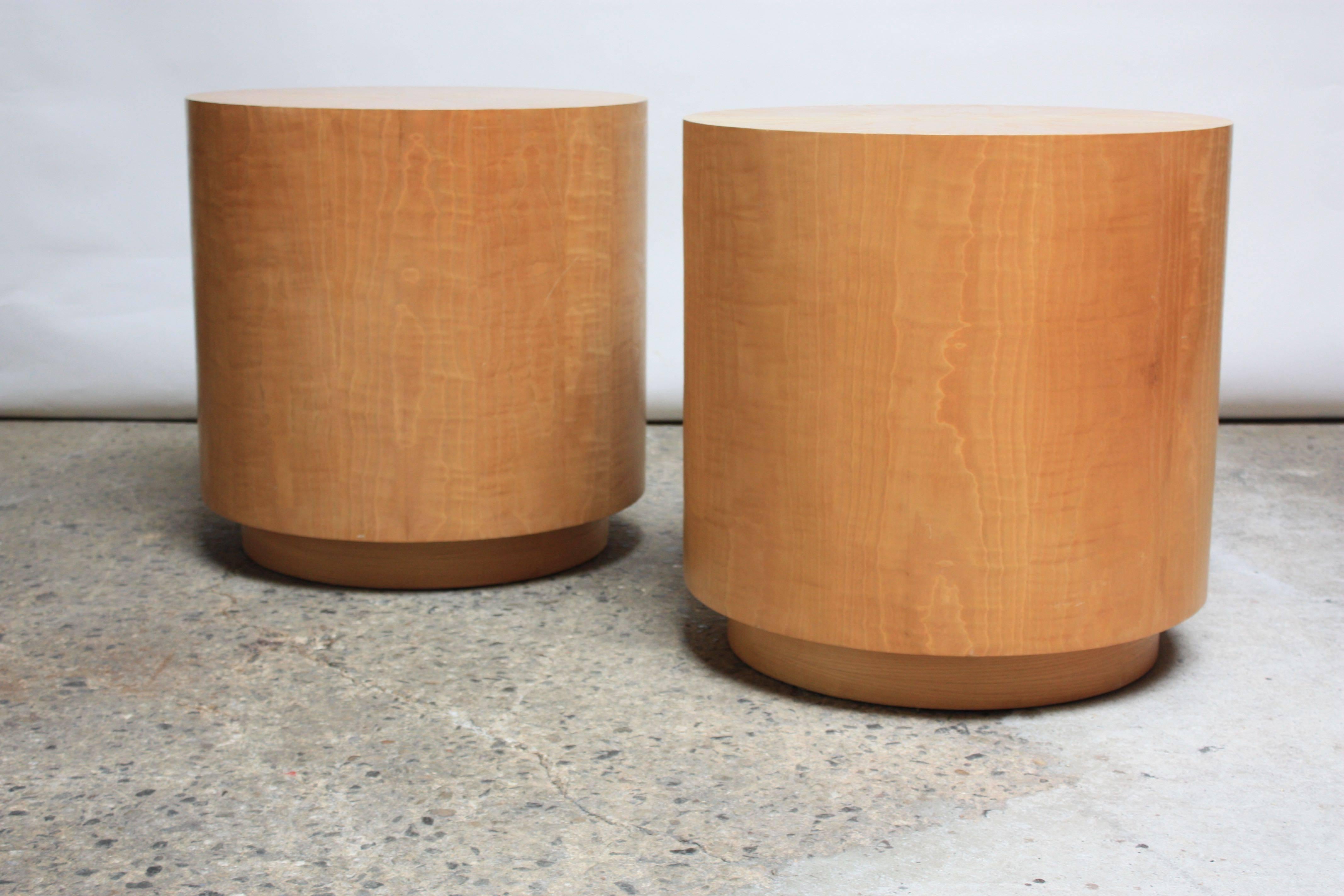 Mid-Century Modern drum pedestals / tables composed of exquisite bookmatched bird's-eye maple veneer. Tables boast beautiful grain, vivid pattern, and impressive size. Can be used as large side tables or display stands. Alternatively, glass tops /