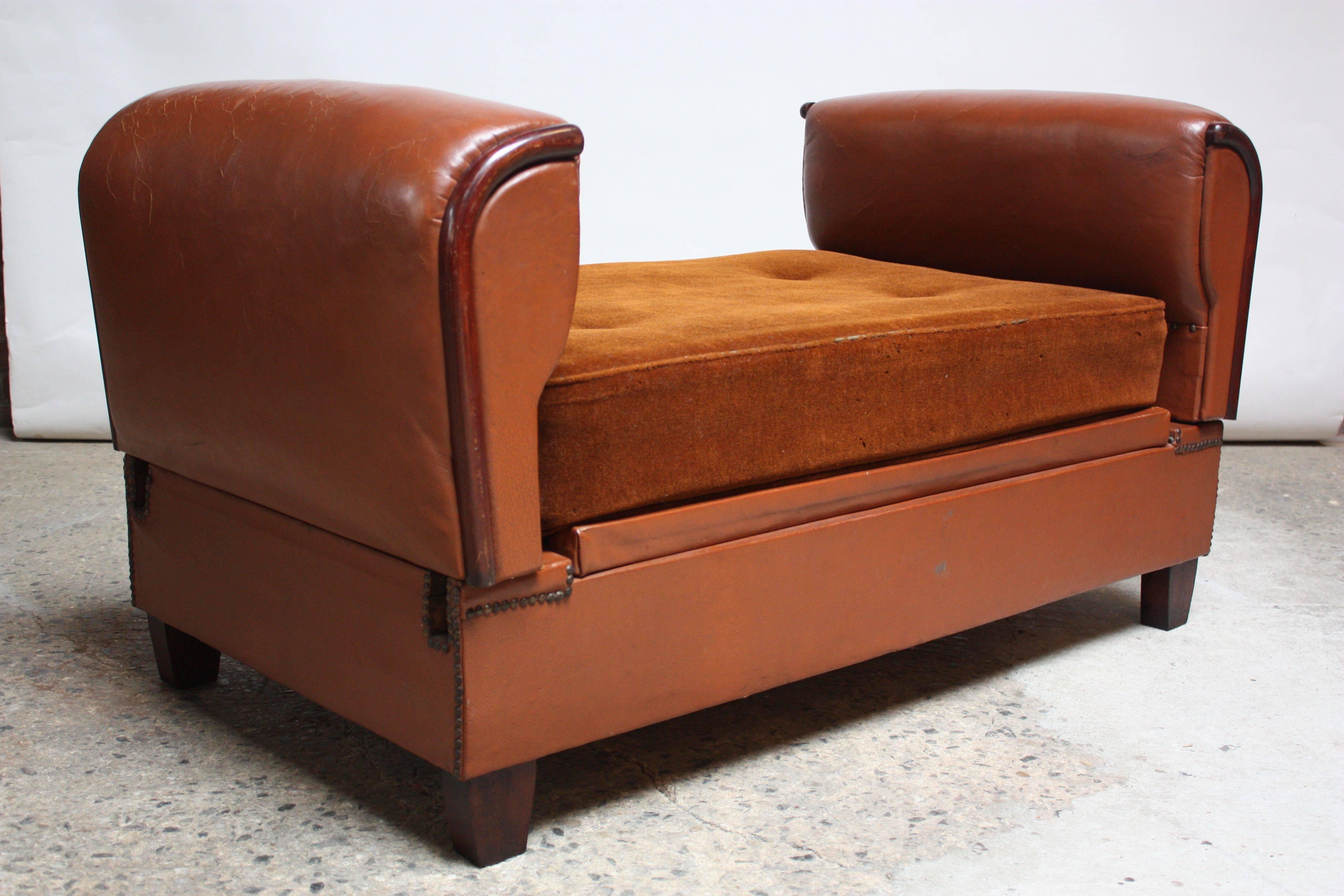 This versatile French deco daybed (circa late 1930s) can be converted from a bench to daybed, when the arms are removed and reoriented into the appropriate frame fittings. The stained mahogany trim complements both the rust-colored mohair cushion