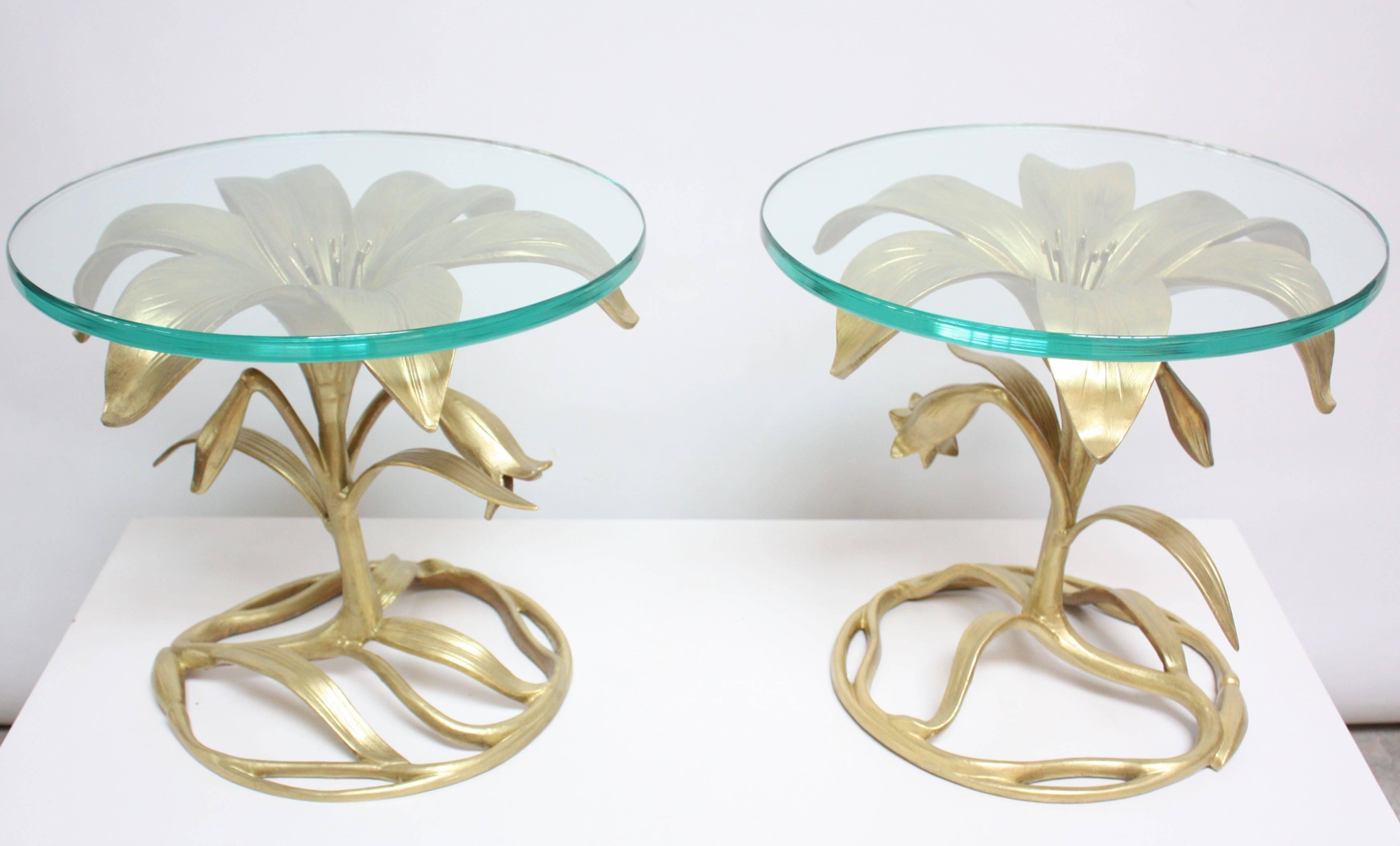 These Arthur Court 'Lily' side tables are composed of gilded and painted aluminium sculptural 'lily' bases with round, beveled glass tops. Glass is original and shows very minimal wear sans one 2