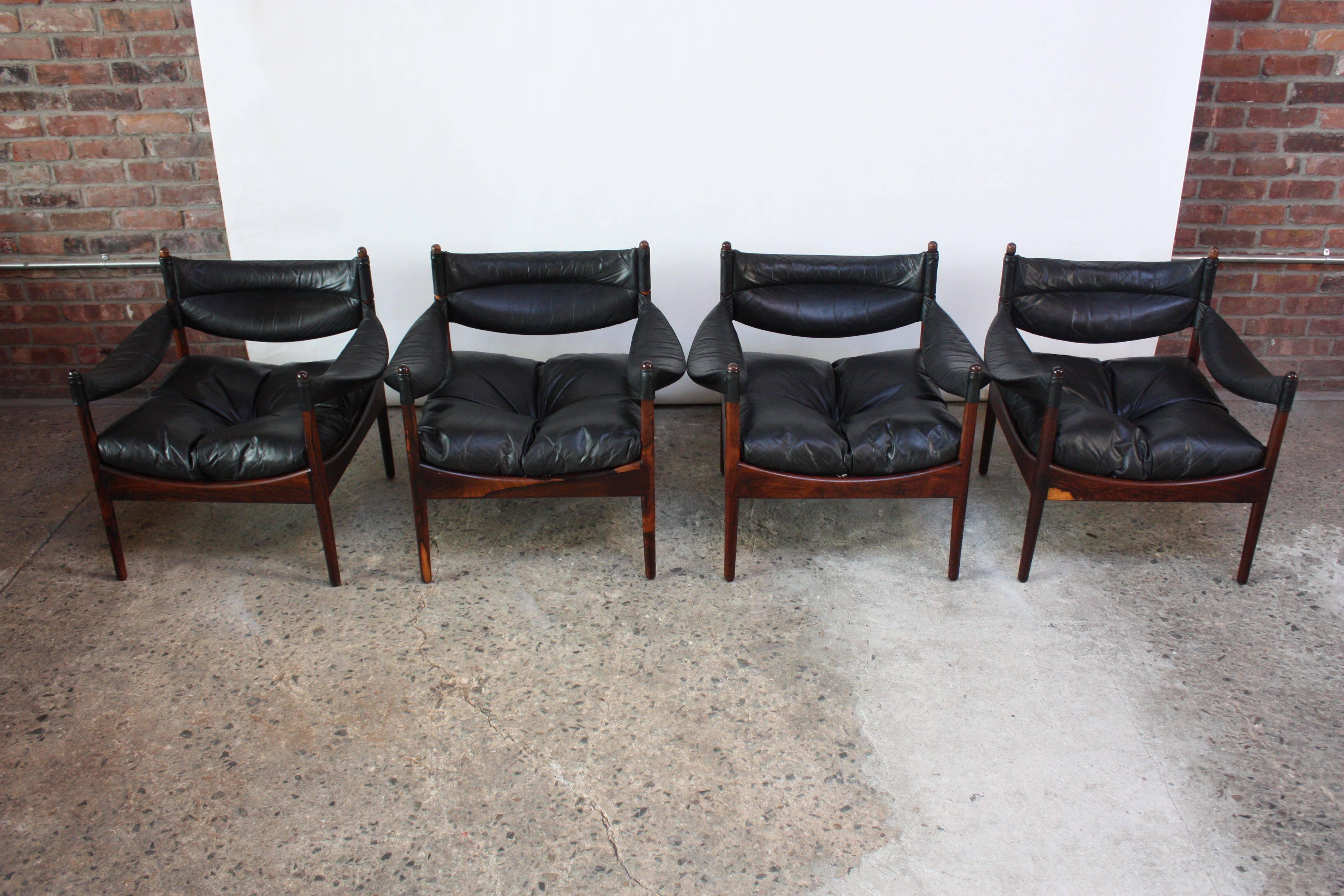 This set of four rosewood and black leather 'Modus' lounge chairs were designed by Kristian Solmer Vedel for Søren Willadsen in 1963. Composed of removable leather armrests, backrests, and seats for easy cleaning. The seat cushions are supported by