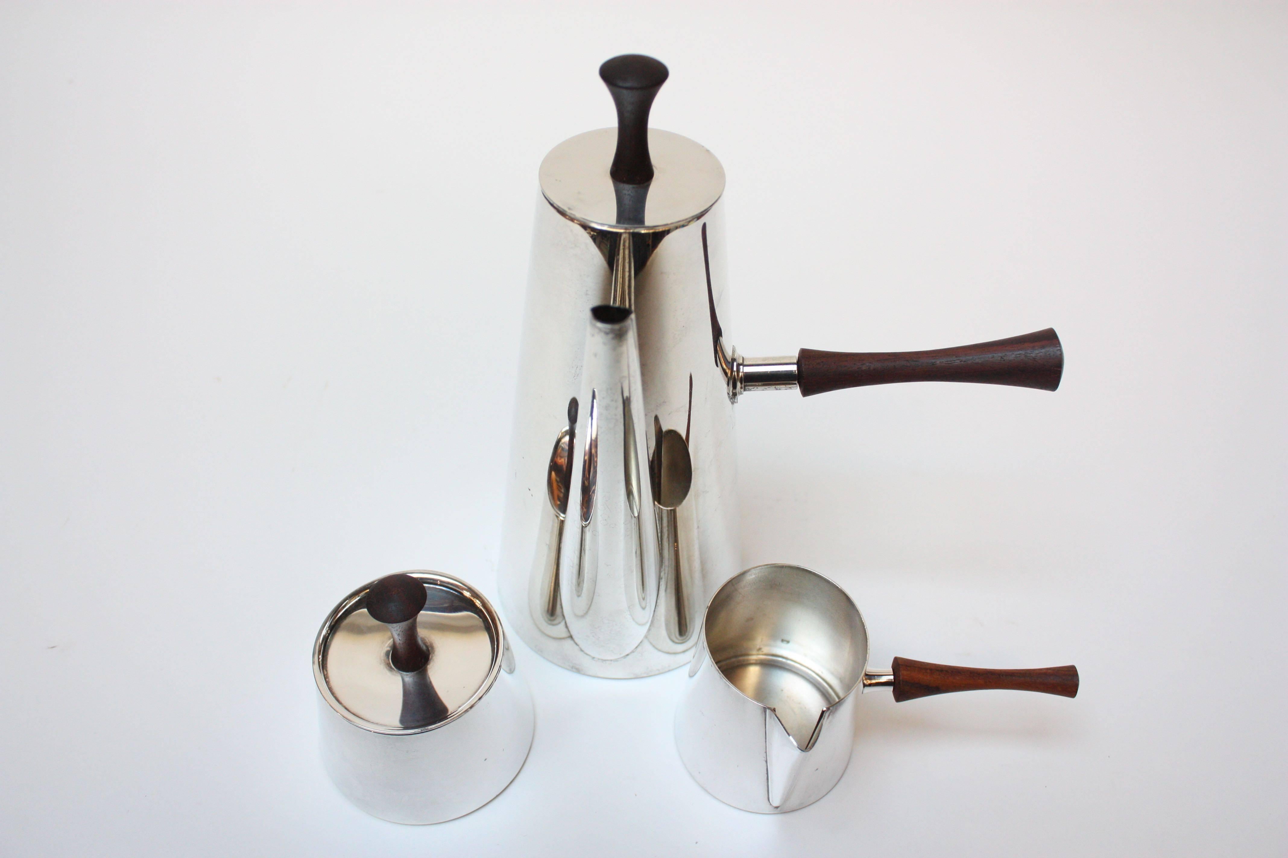 Complete 1950s Italian coffee set, including lidded-pot, lidded-sugar, and creamer, all composed of silver plate with rosewood handles. Excellent, polished condition, bearing the 'Made in Italy' brand to the underside.
Pot measures: H: 9.5