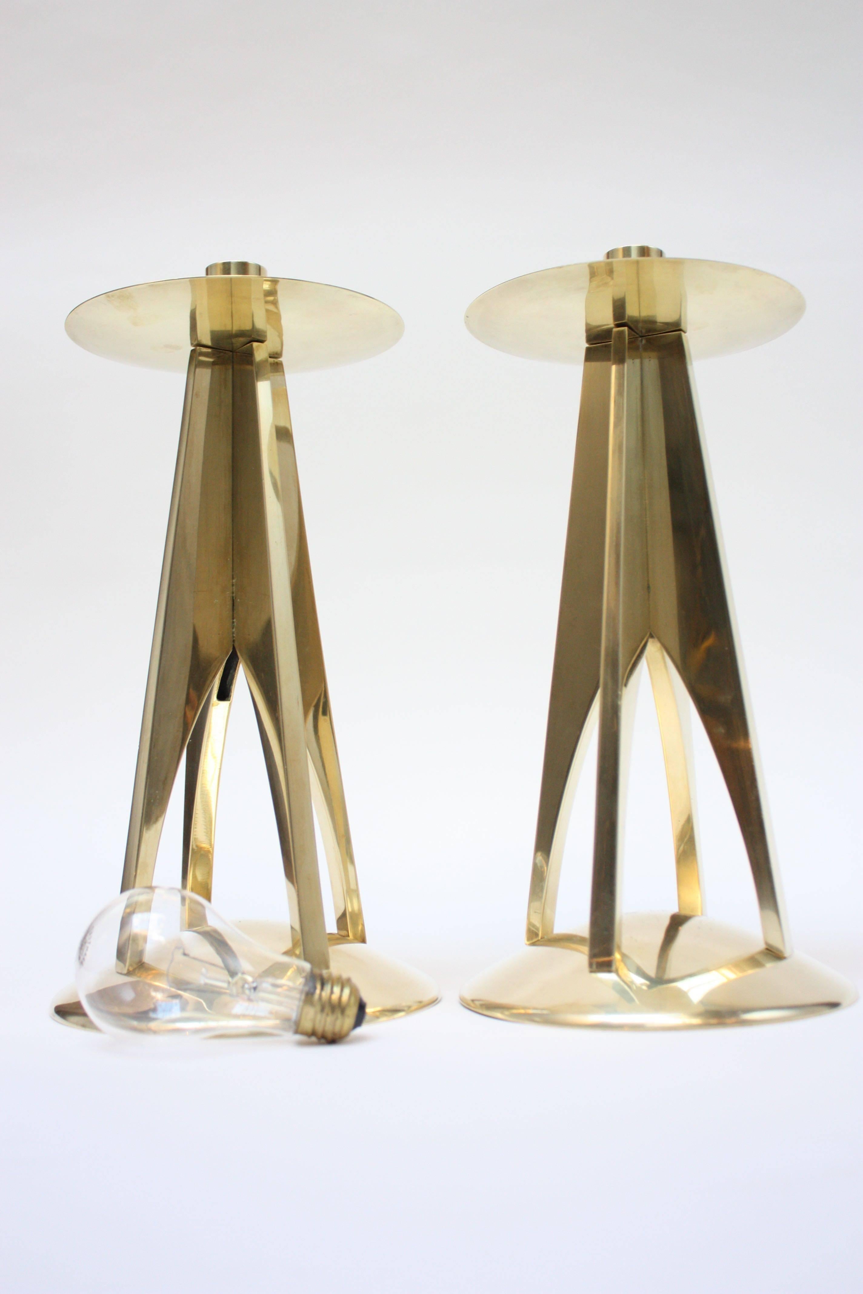 Substantial pair of polished brass American Modern candlesticks. Sculptural form and impressive size. (Standard lightbulb present in photo for scale.) Accommodates a candle 1" in diameter.