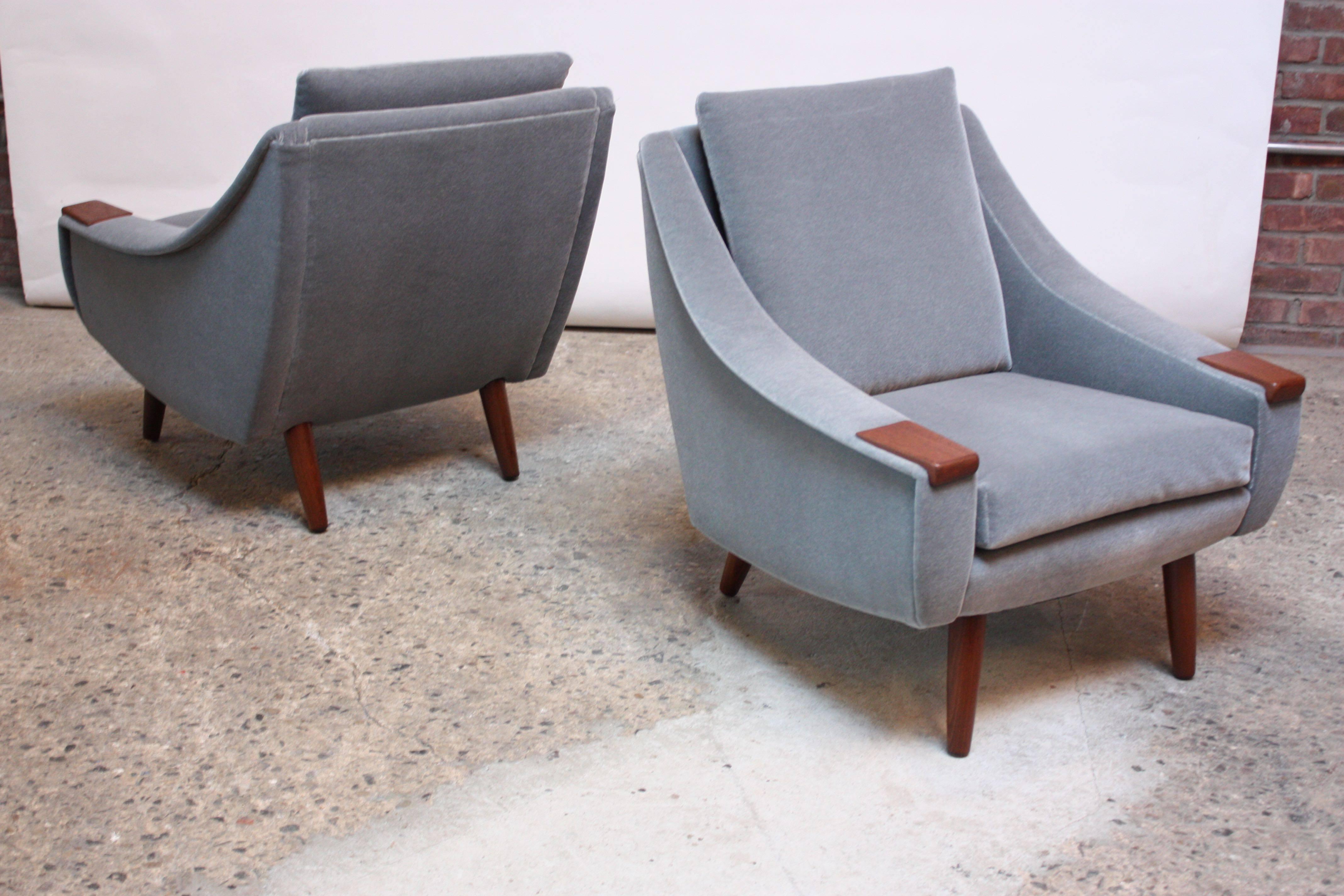 Pair of 1960s Danish lounge chairs newly upholstered in a powder blue mohair with teak armrests raised on turned teak legs. Elegant, clean lines and lovely teak grain.
Height to the top of the frame is: 29" (the back cushion increases the
