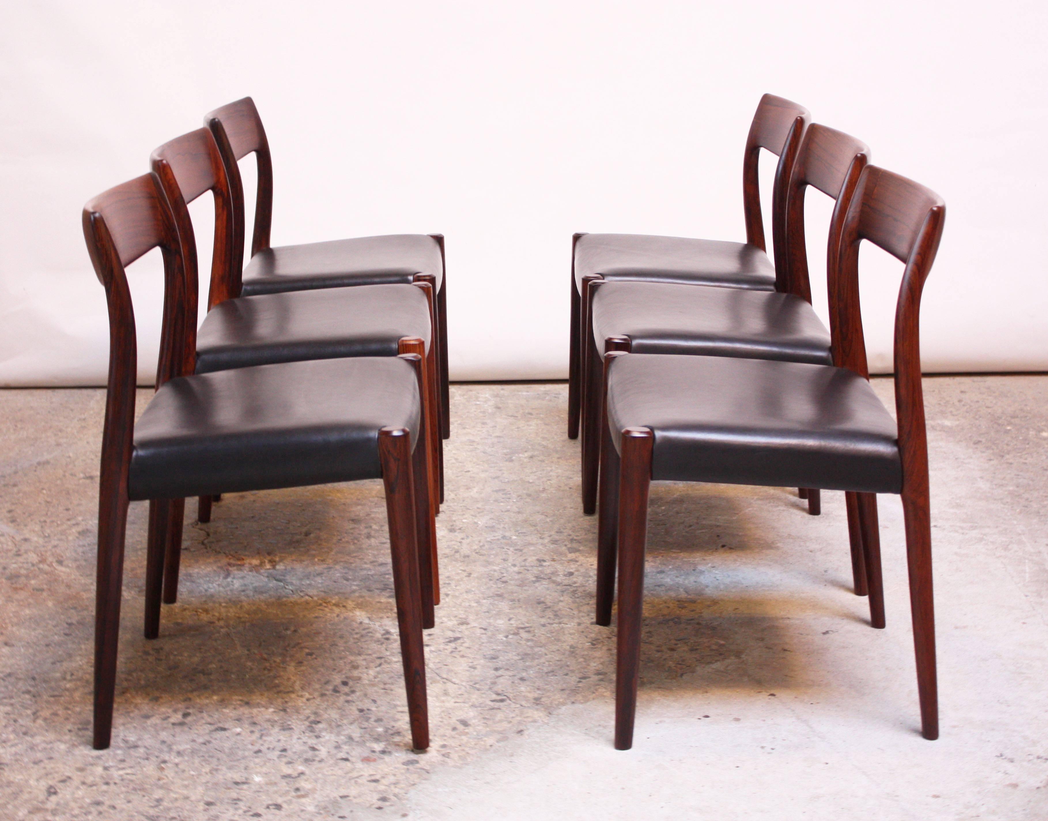 Set of six model #77 chairs in rosewood designed in 1959 by Niels Ole Møller for J.L.Møllers Stolefabrik of Denmark. Sculptural rosewood frame with vivid grain and rich color with newly upholstered black leather seat.