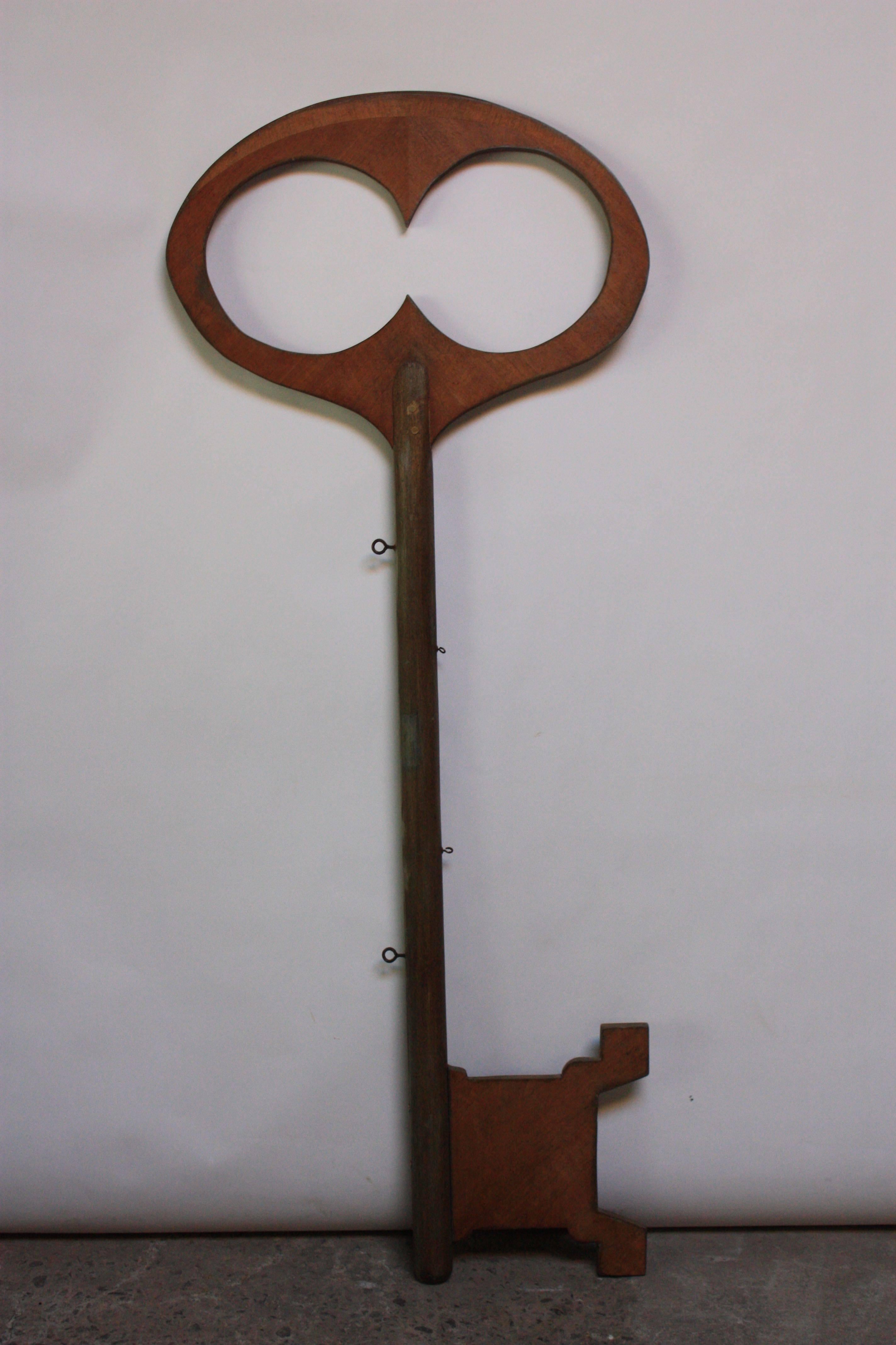 This 1960s large Folk Art key (70.5" L) was likely an advertising piece. It was made for display purposes and wood have been suspended in front of a retail location.