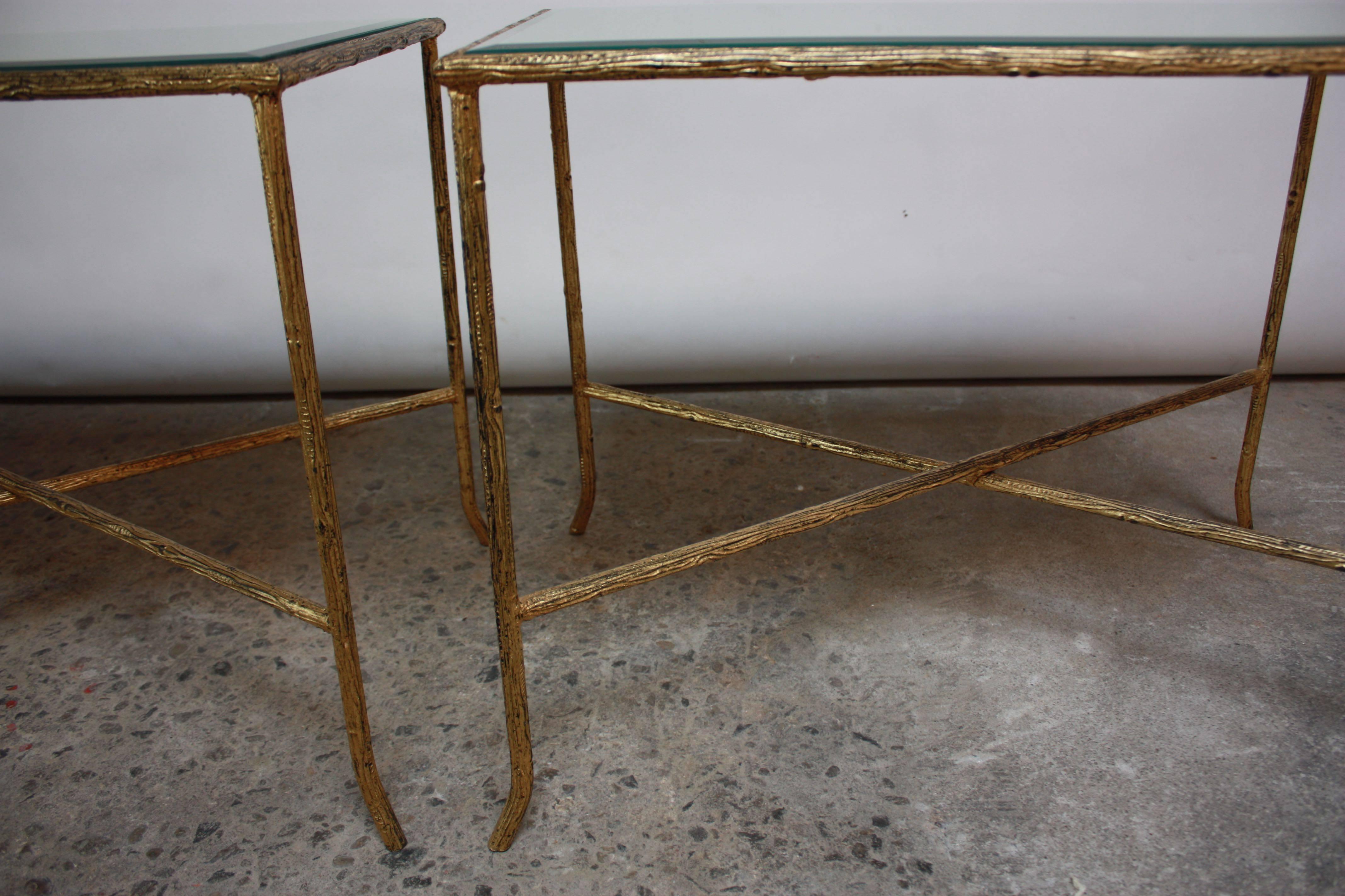 These Italian end tables are comprised of a heavily textured gilded-steel X-base frame and beveled mirror inserts. There is one scratch to one of the mirror tops, but otherwise these tables are in excellent, vintage condition.