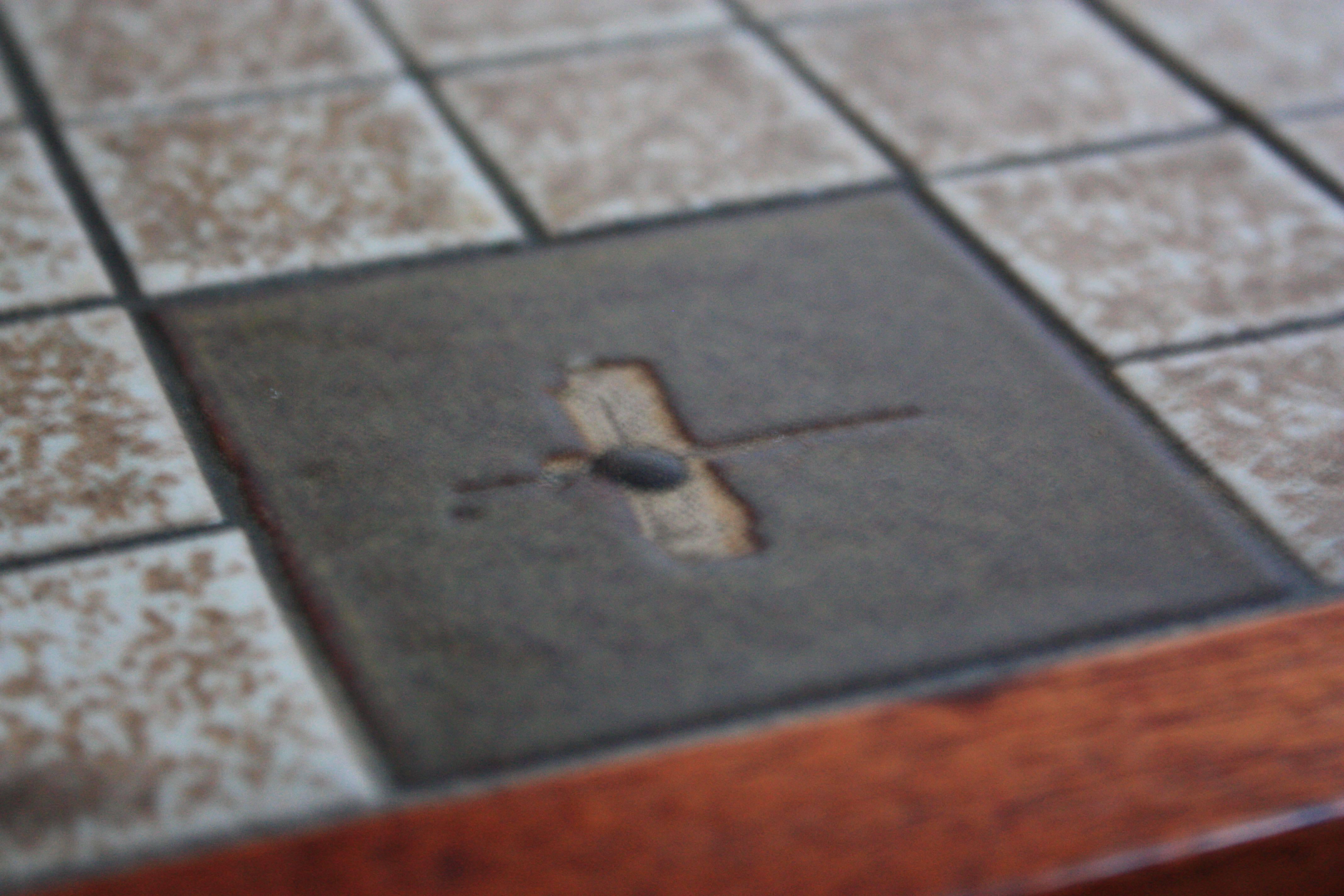 This tile-top dining table designed by Gordon Martz for Marshall Studios sits upon four removable walnut, tapered legs and is framed by a thin, walnut border. This is a custom-made, large, dining example (listed separately is the small, occasional /