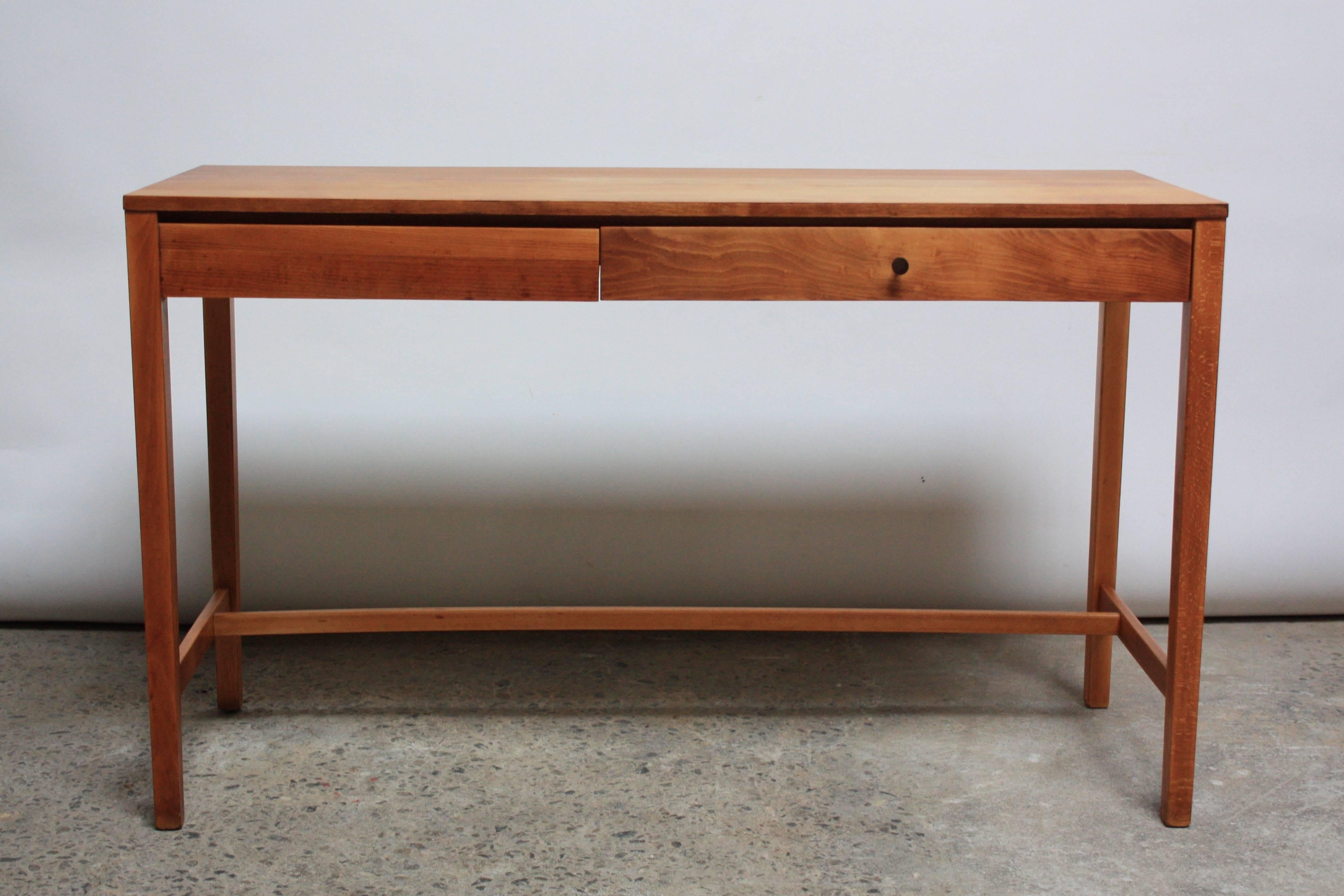 This elegant, minimal writing desk was designed by Paul Mccobb for Winchedon Furniture for the Perimeter Group Line. The maple is subtly offset by a rosewood pull for the single drawer. 