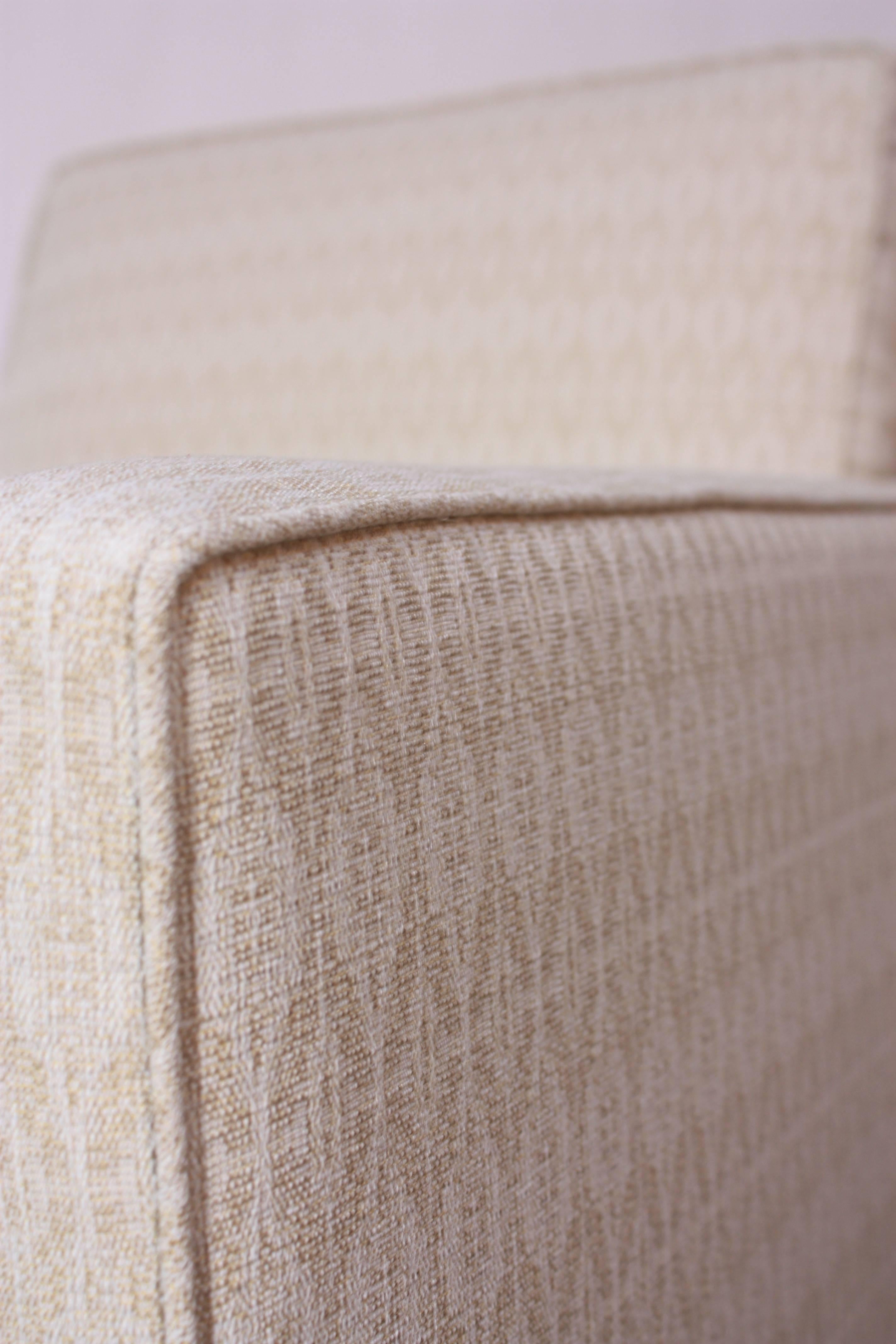 Ce luxueux fauteuil de salon W & J Sloane présente des lignes épurées de style Mid-Century Modern et une assise robuste et accueillante. En plus d'être retapissé dans un fin tweed blanc et blé composé d'un motif géométrique en forme de diamant, il