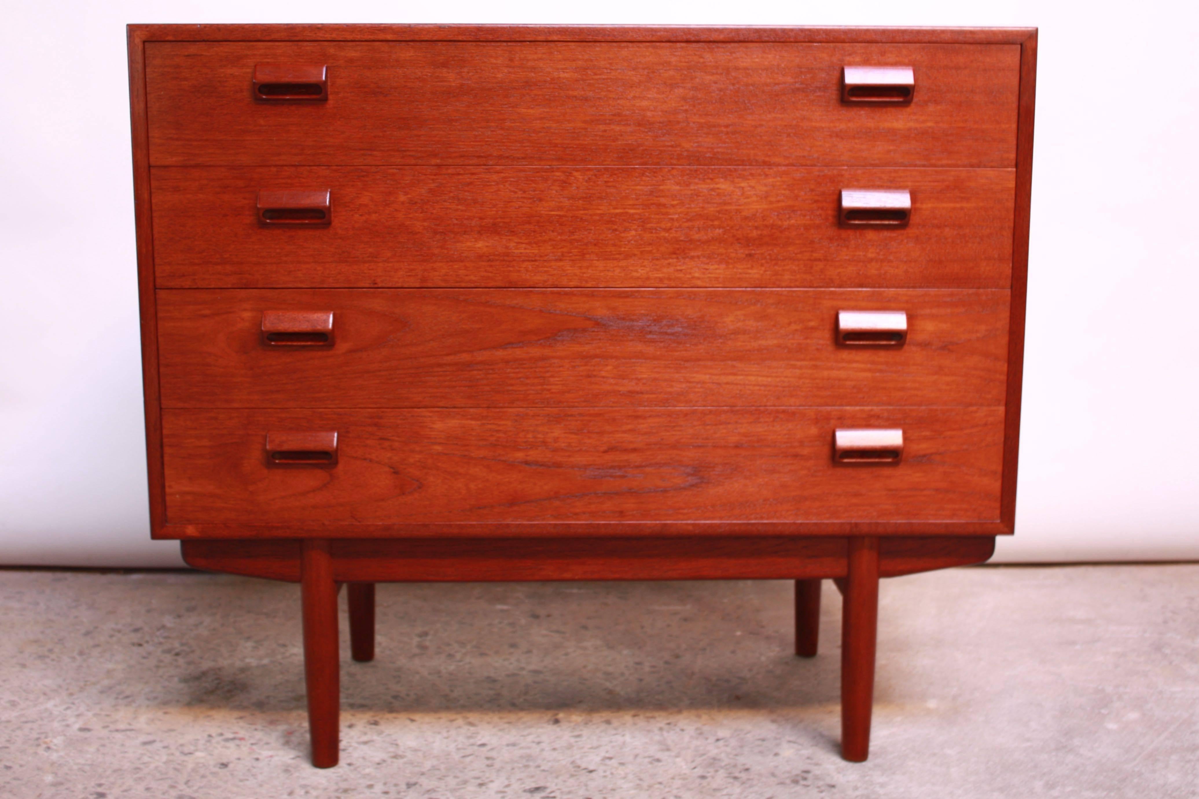 This teak chest was designed by Børge Mogensen for Soborg Mobler in the 1950s. It has four drawers with sculptural, block pulls and a sled base. 
We have a total of two available that can be sold together as a pair, if desired. The overall darker
