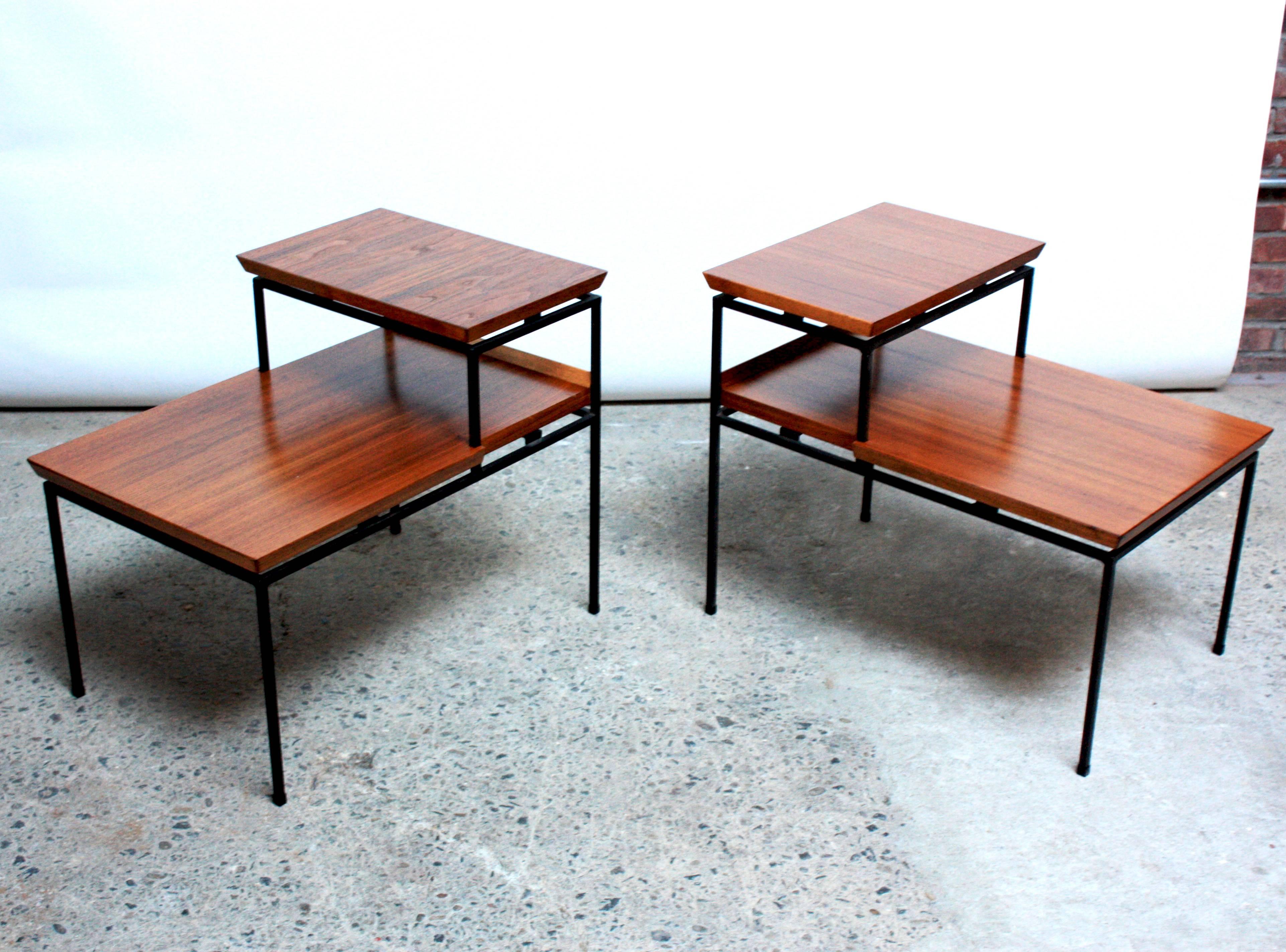 These minimal side tables comprised of iron frames and walnut tops were designed and manufactured by the Furnwood Corporation of Brockton, MA in the 1950s. Furnwood Corp was a very small company, and these pieces are rarely seen and hardly ever